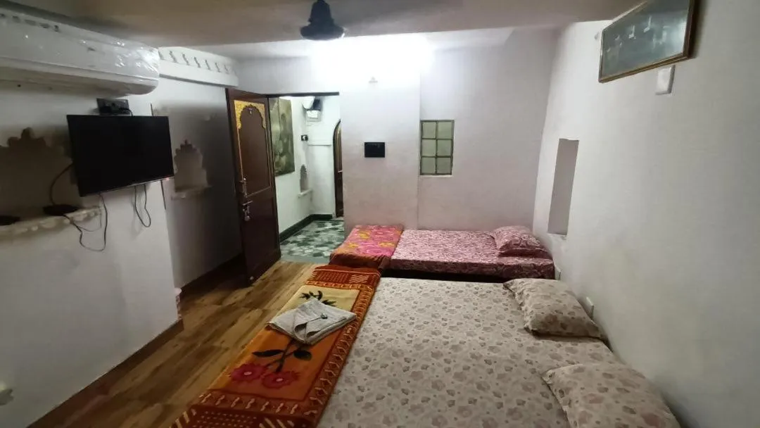 Photo of the whole room, Bed in Jag Niwas Guest House & pure veg restaurant