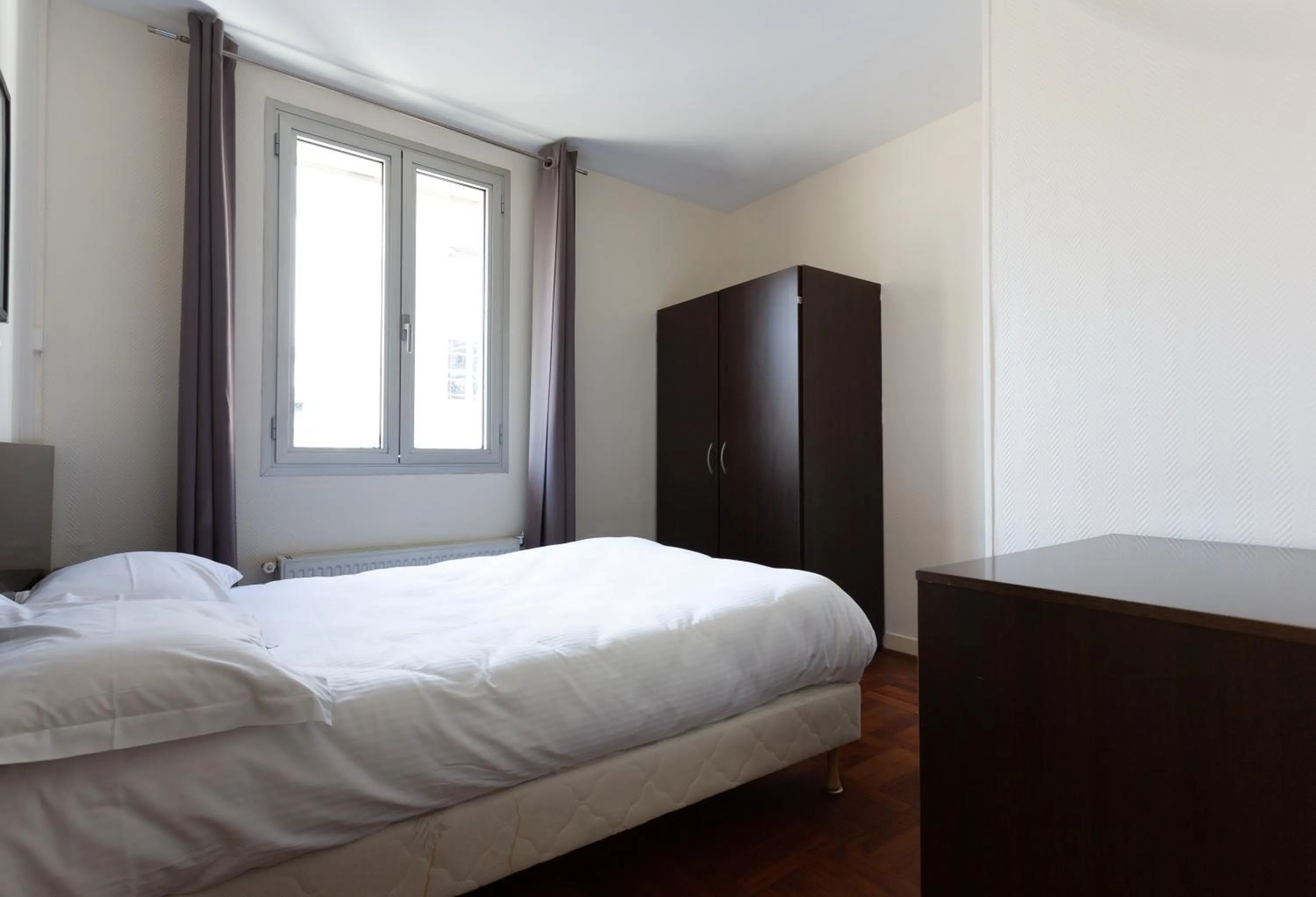 Bed in Hotel Mimosa Paris