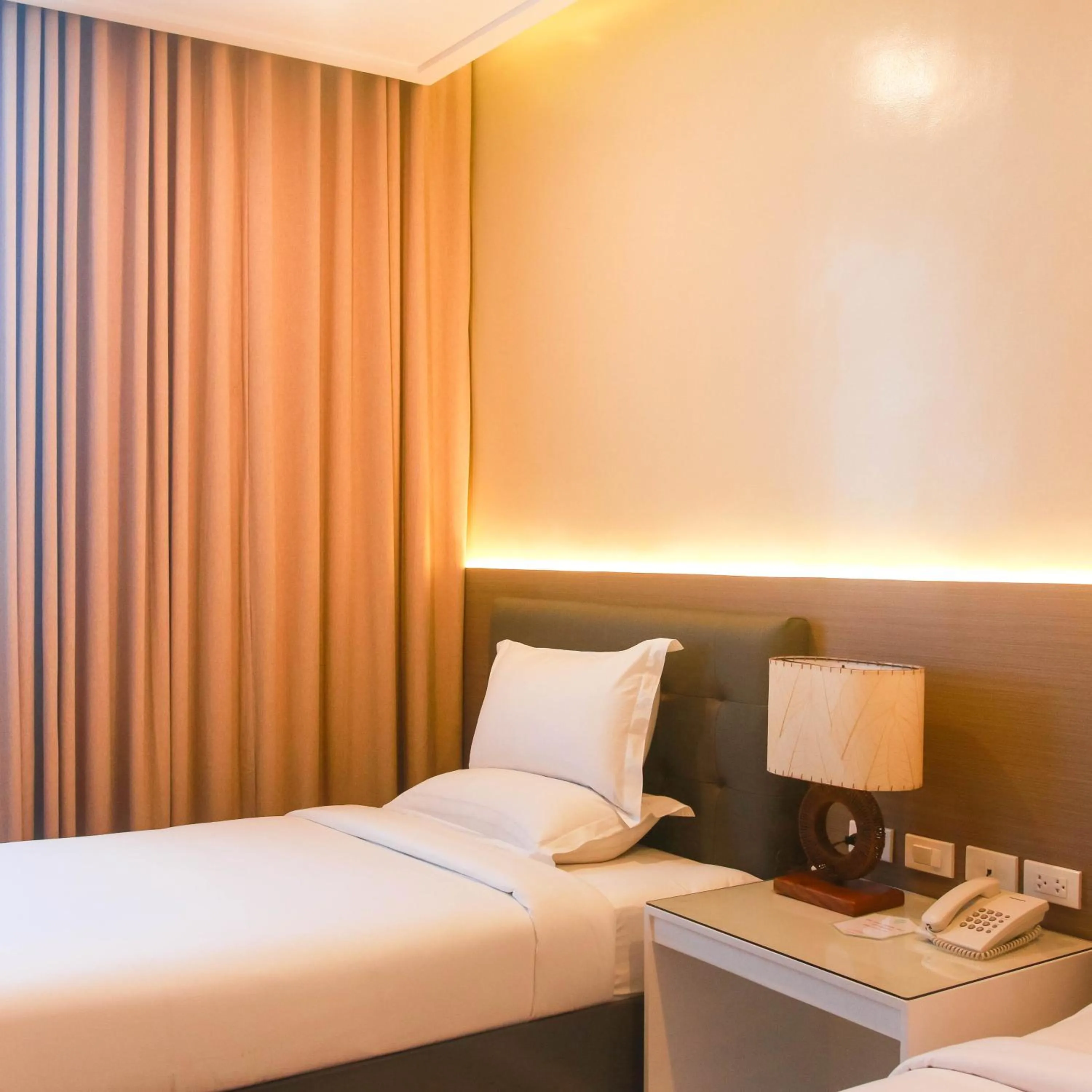 Bed in Iloilo Gateway Hotel and Suites