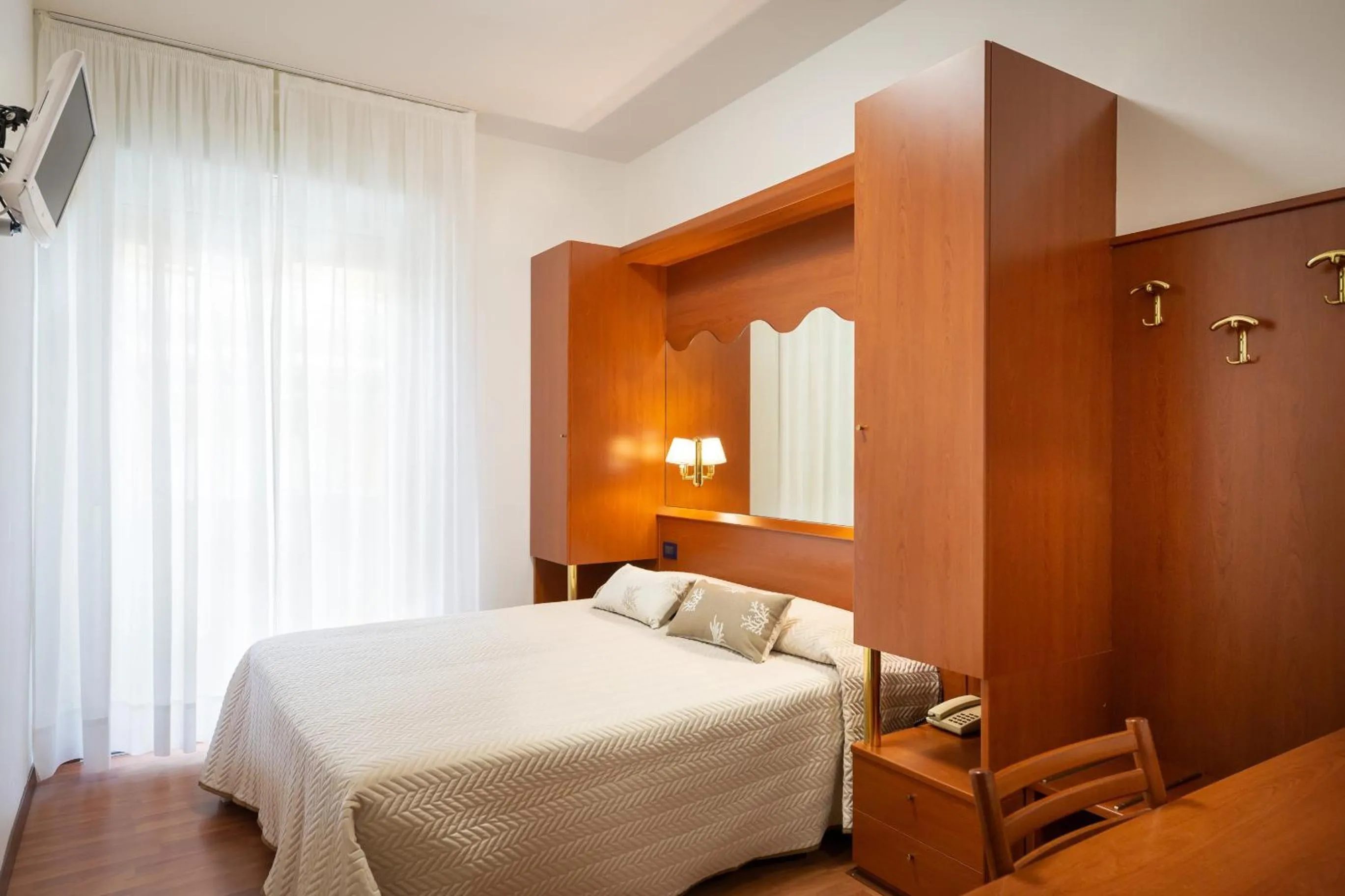 Bed in Hotel Delfino
