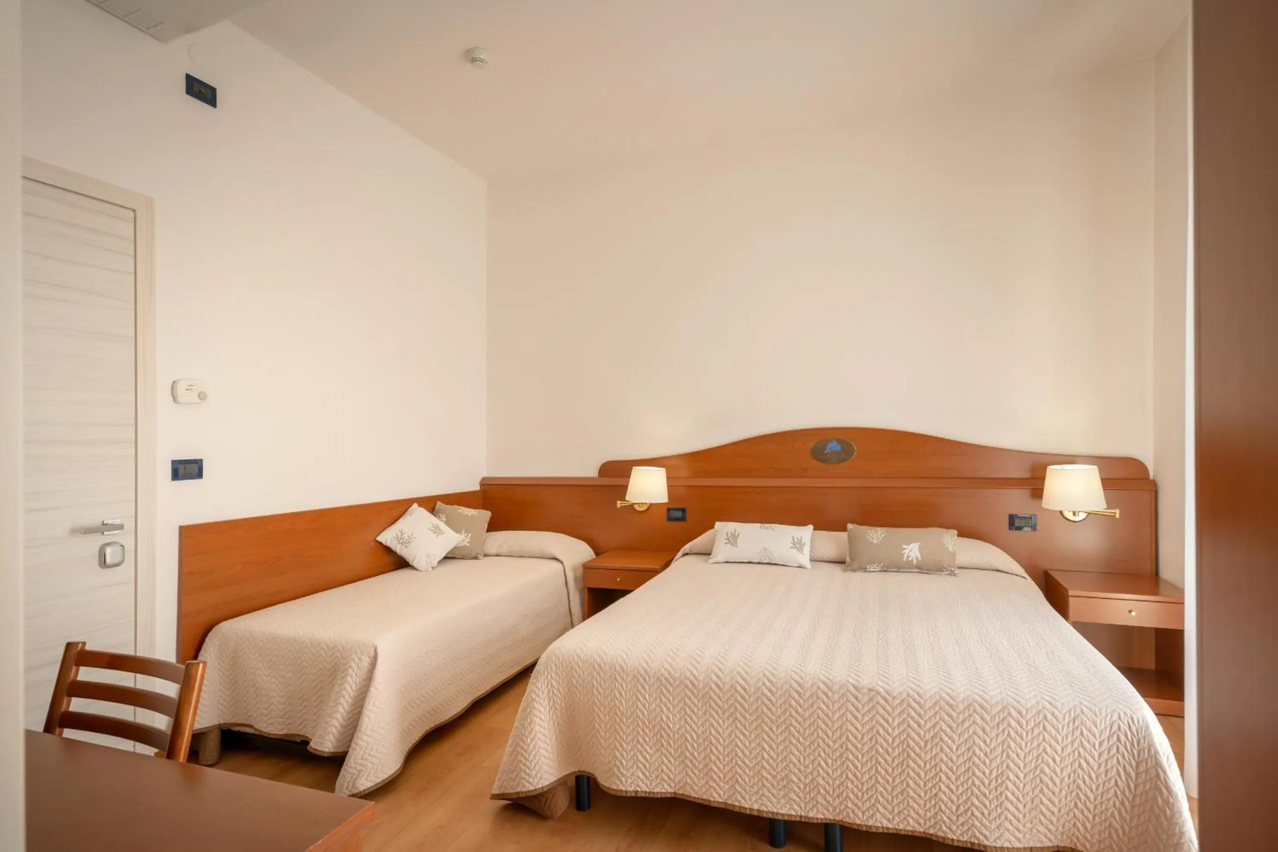 Bed in Hotel Delfino