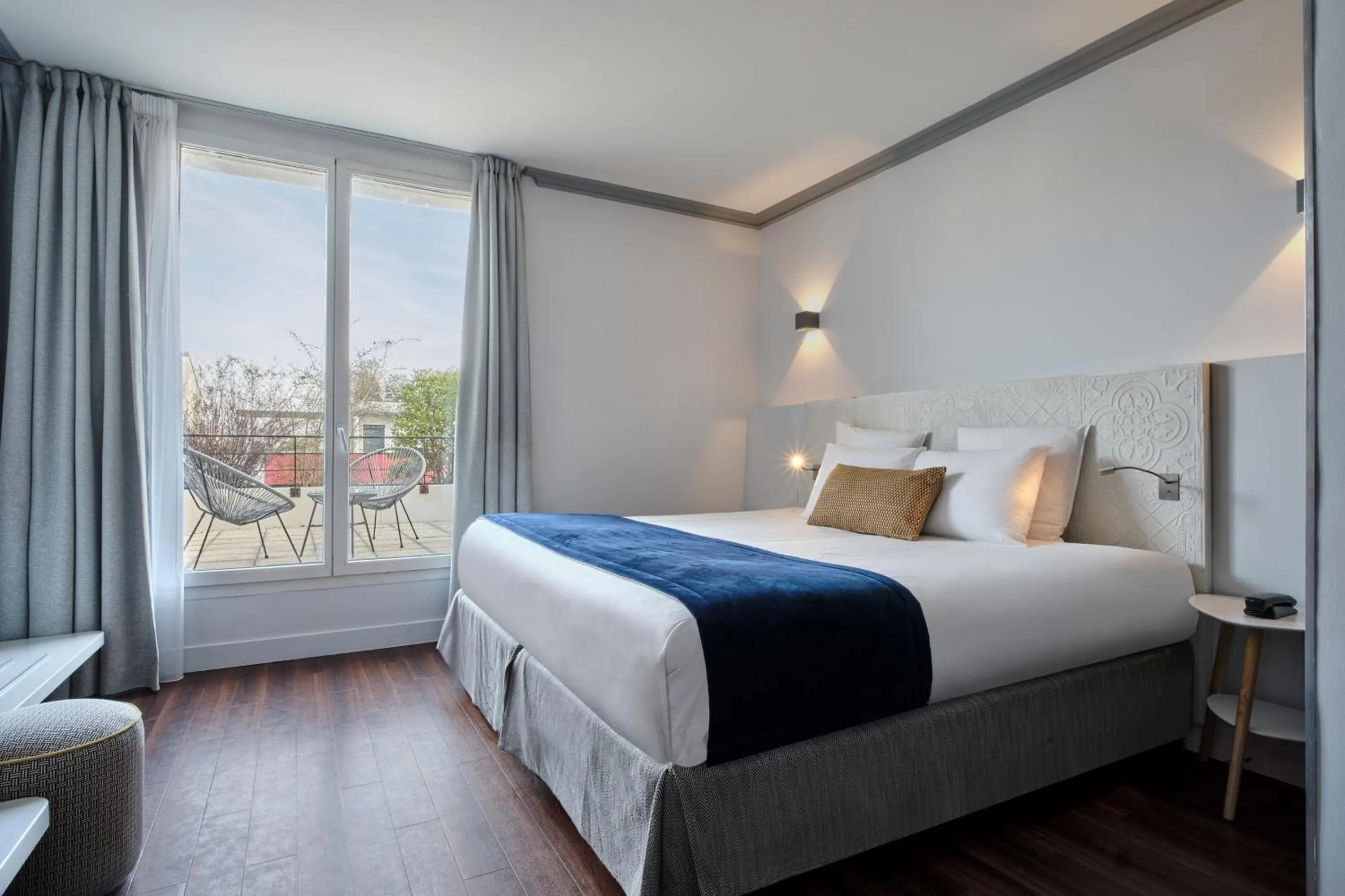 Bed in Hotel Atrium by Happyculture