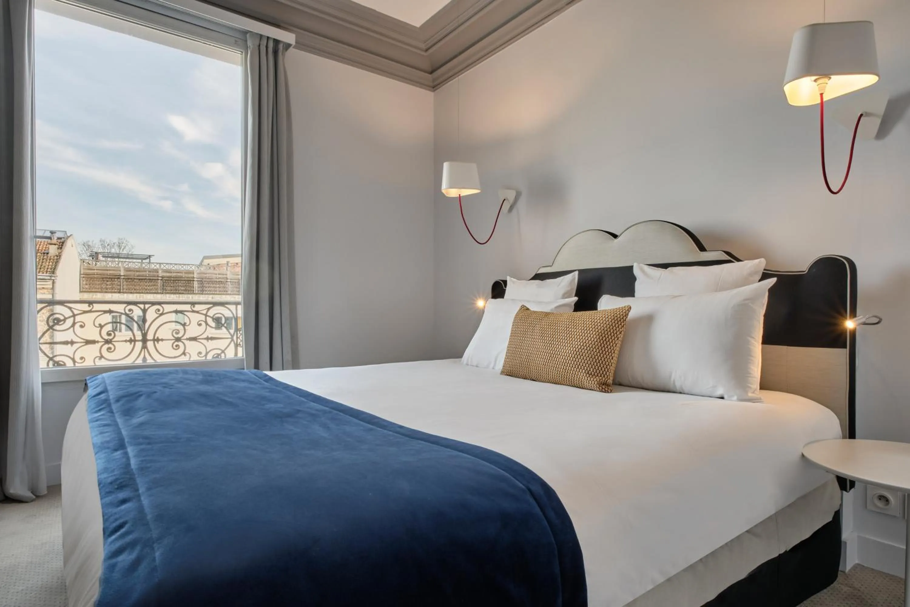 Bed in Hotel Atrium by Happyculture