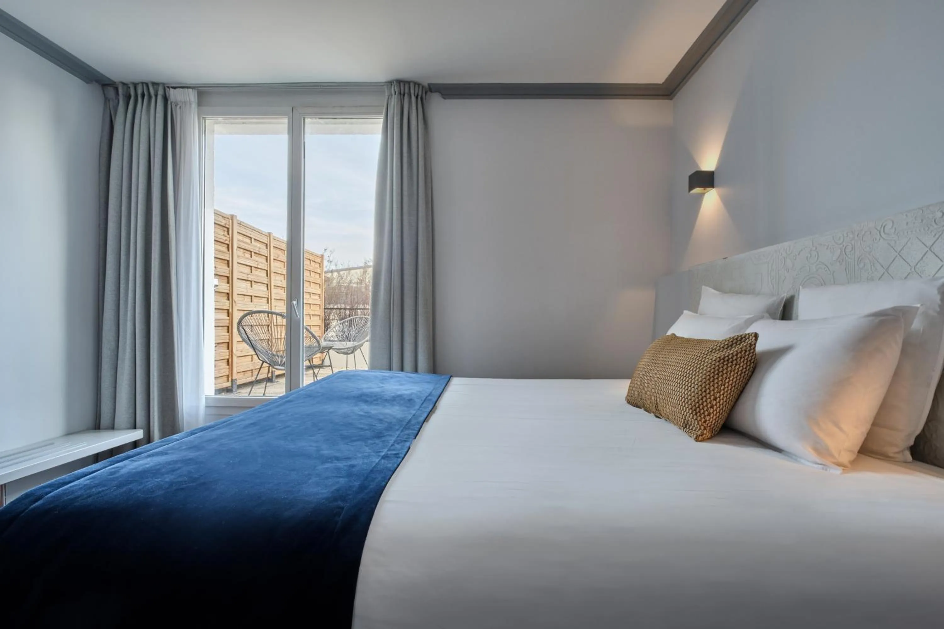 Bed in Hotel Atrium by Happyculture