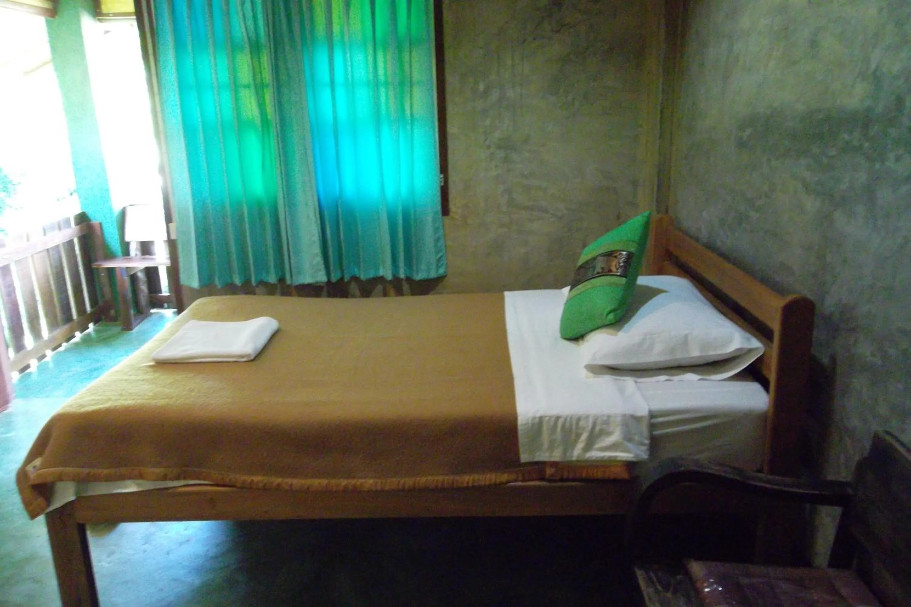 Bed in Tamarind Grand Resort Mae Sariang