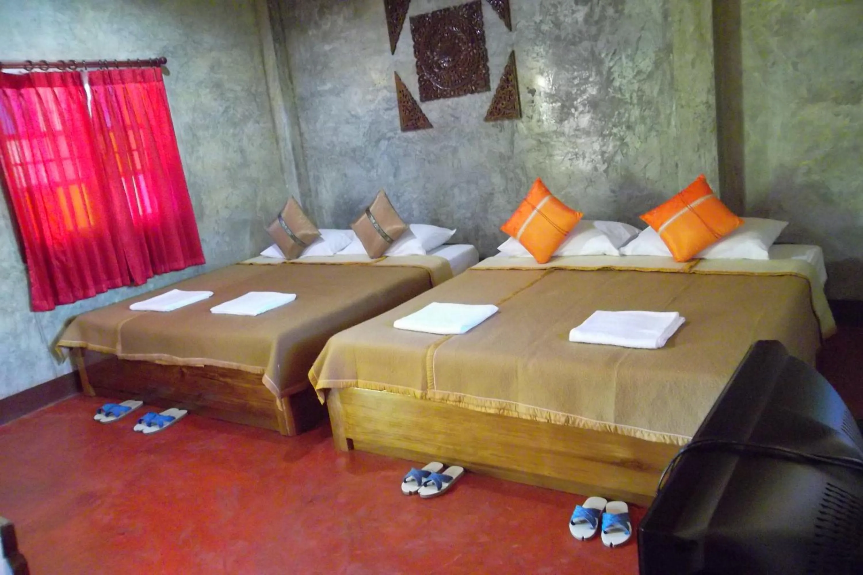 Bed in Tamarind Grand Resort Mae Sariang