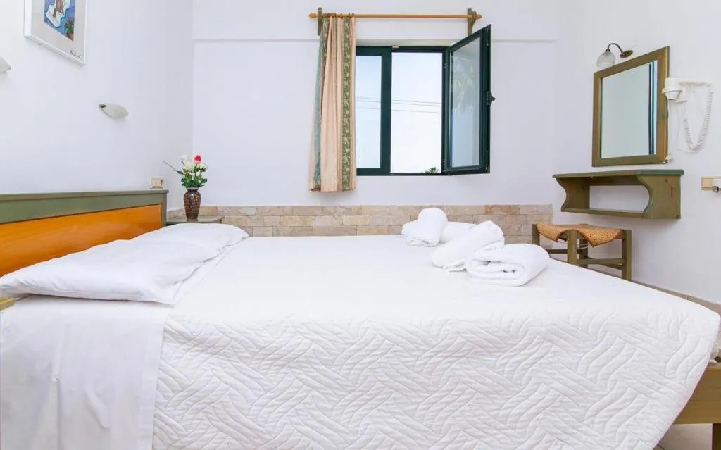 Bed in Dionysos Apartments & Studios