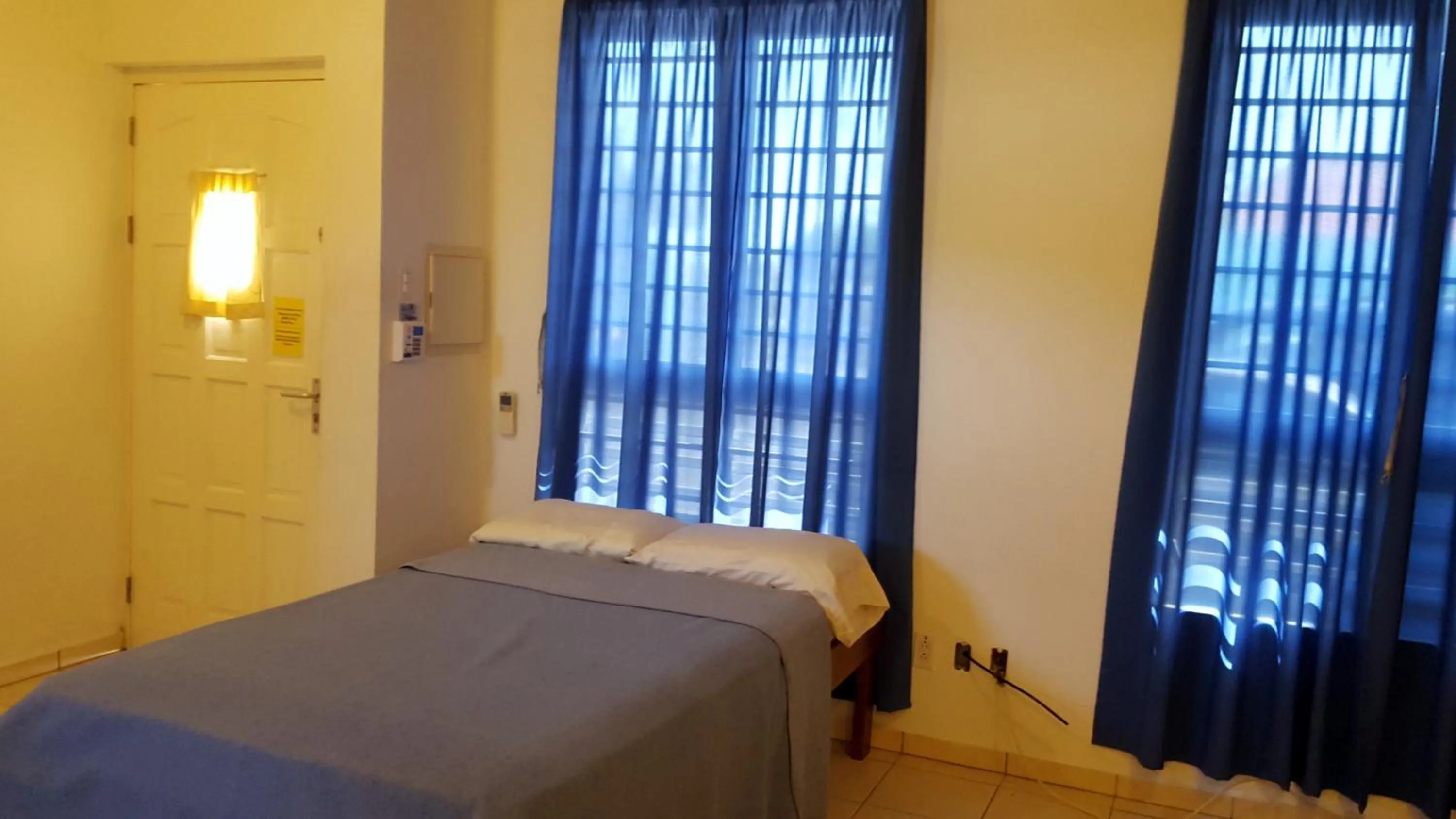 Bed in Orange Rembrandt Studio Apartments