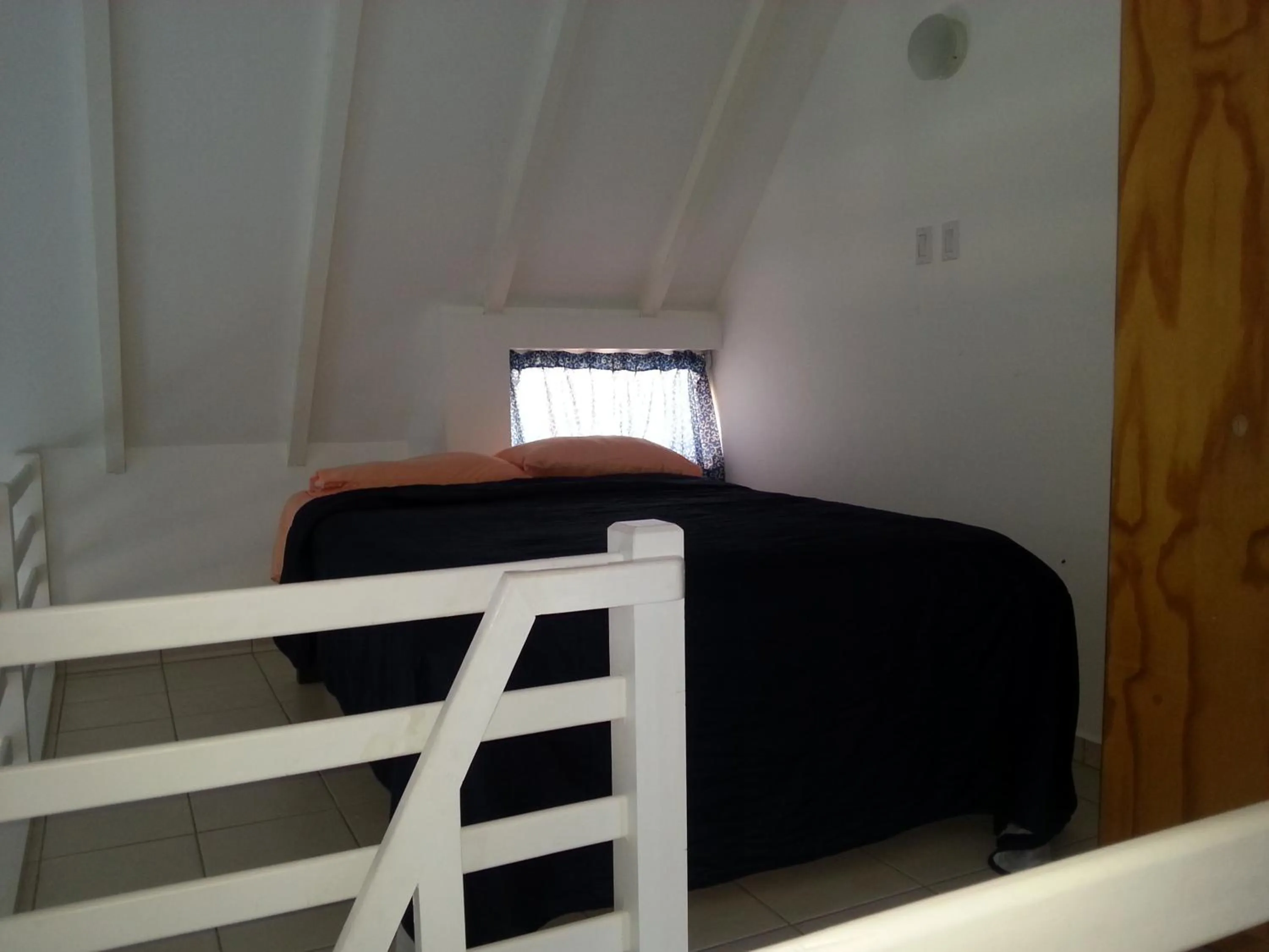 Bed in Orange Rembrandt Studio Apartments