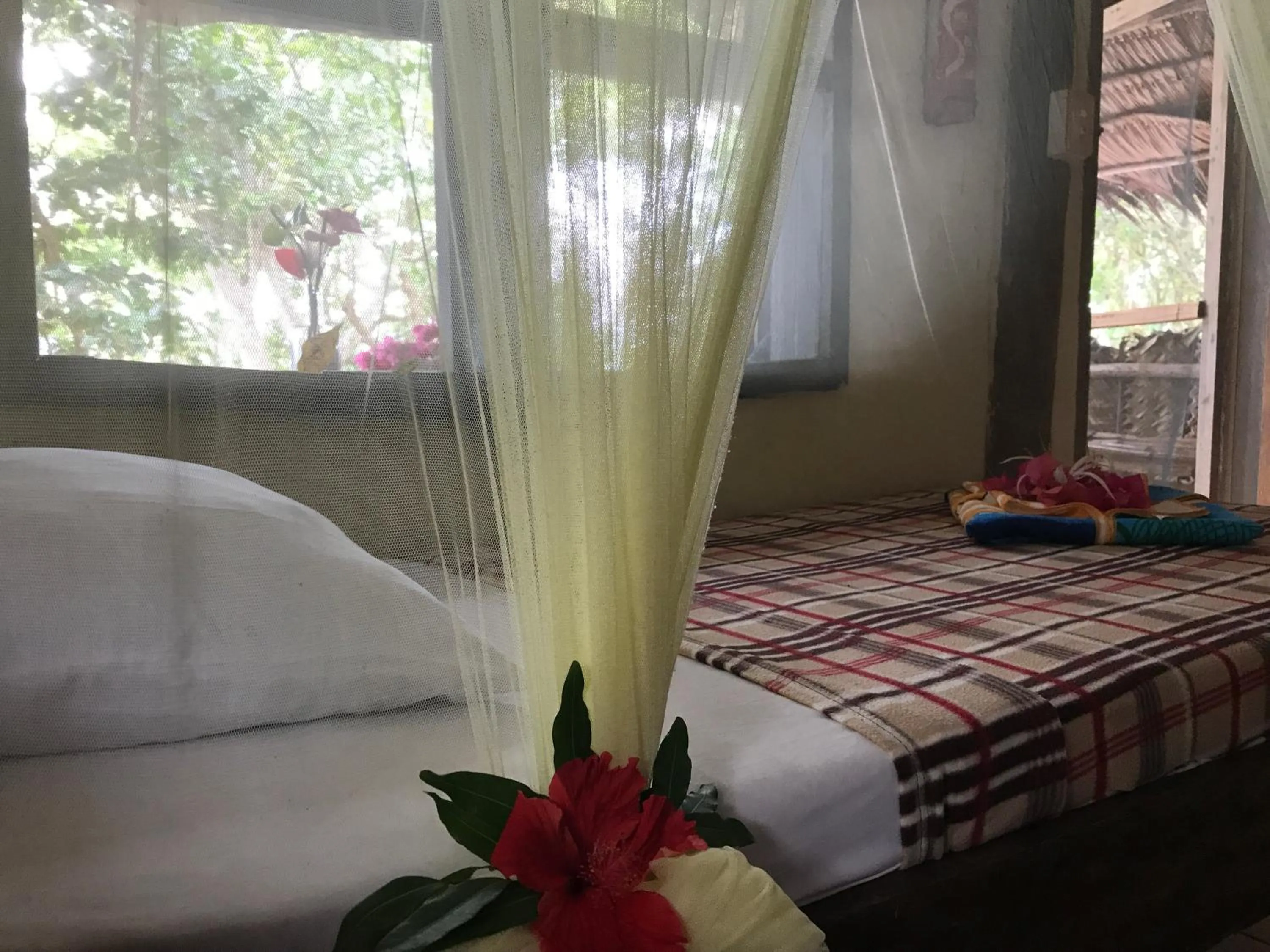 Bed in Tranquility Island Eco Dive Resort