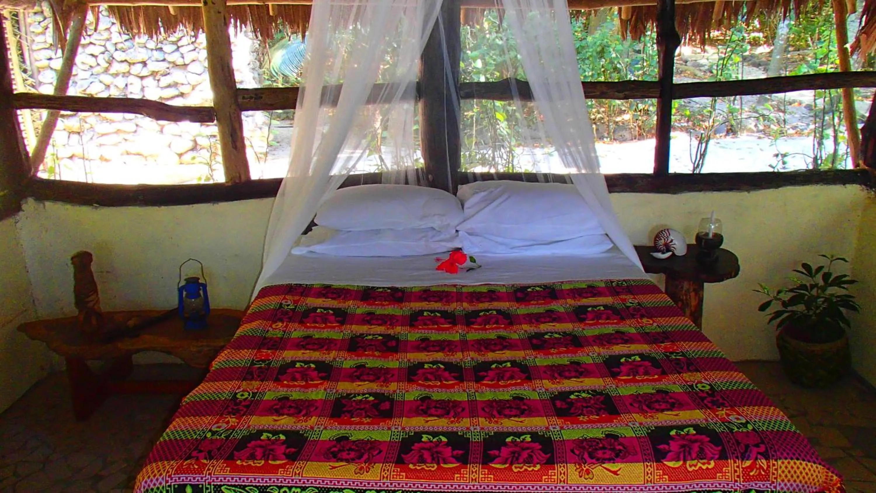 Bed in Tranquility Island Eco Dive Resort