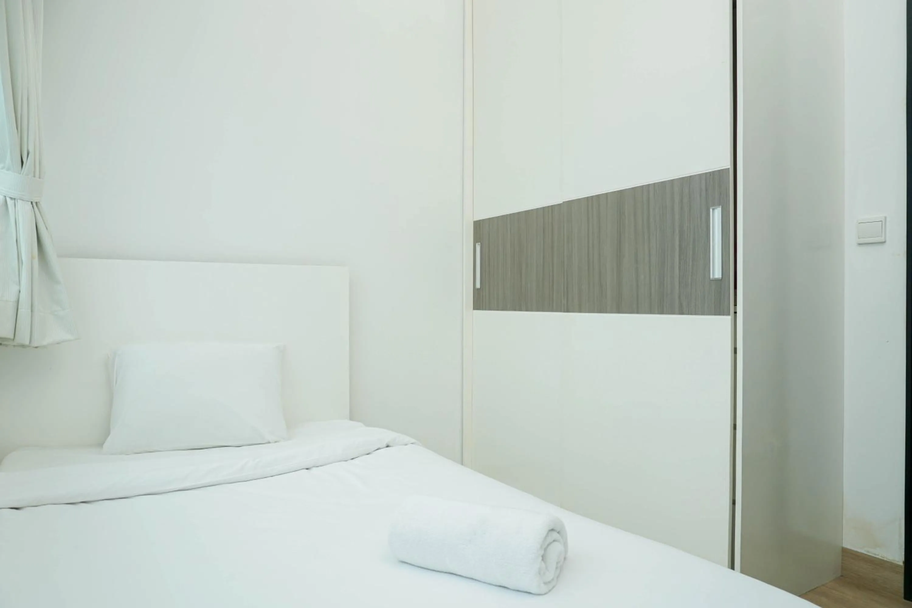 Bed in Spacious 3BR Ambassade Kuningan Apartment By Travelio
