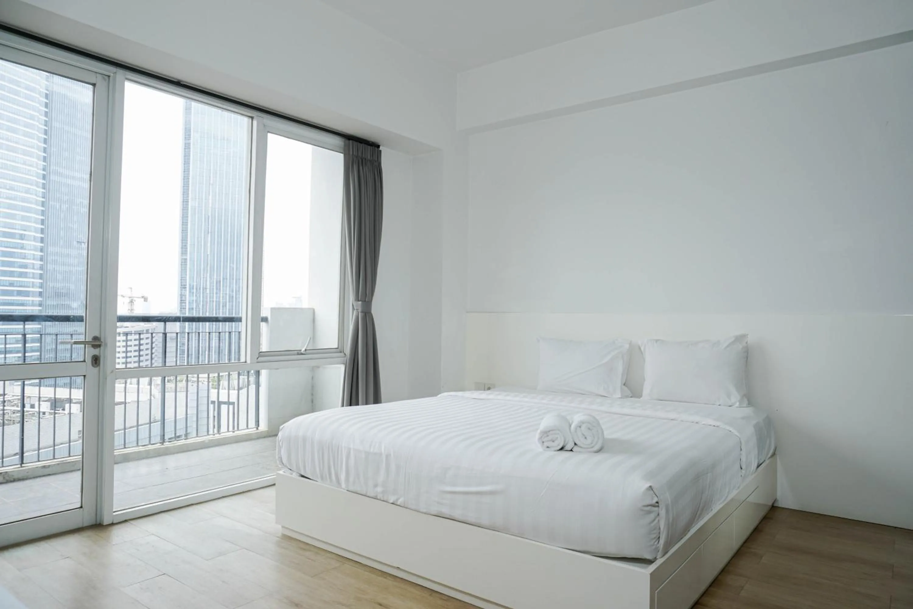 Bed in Spacious 3BR Ambassade Kuningan Apartment By Travelio
