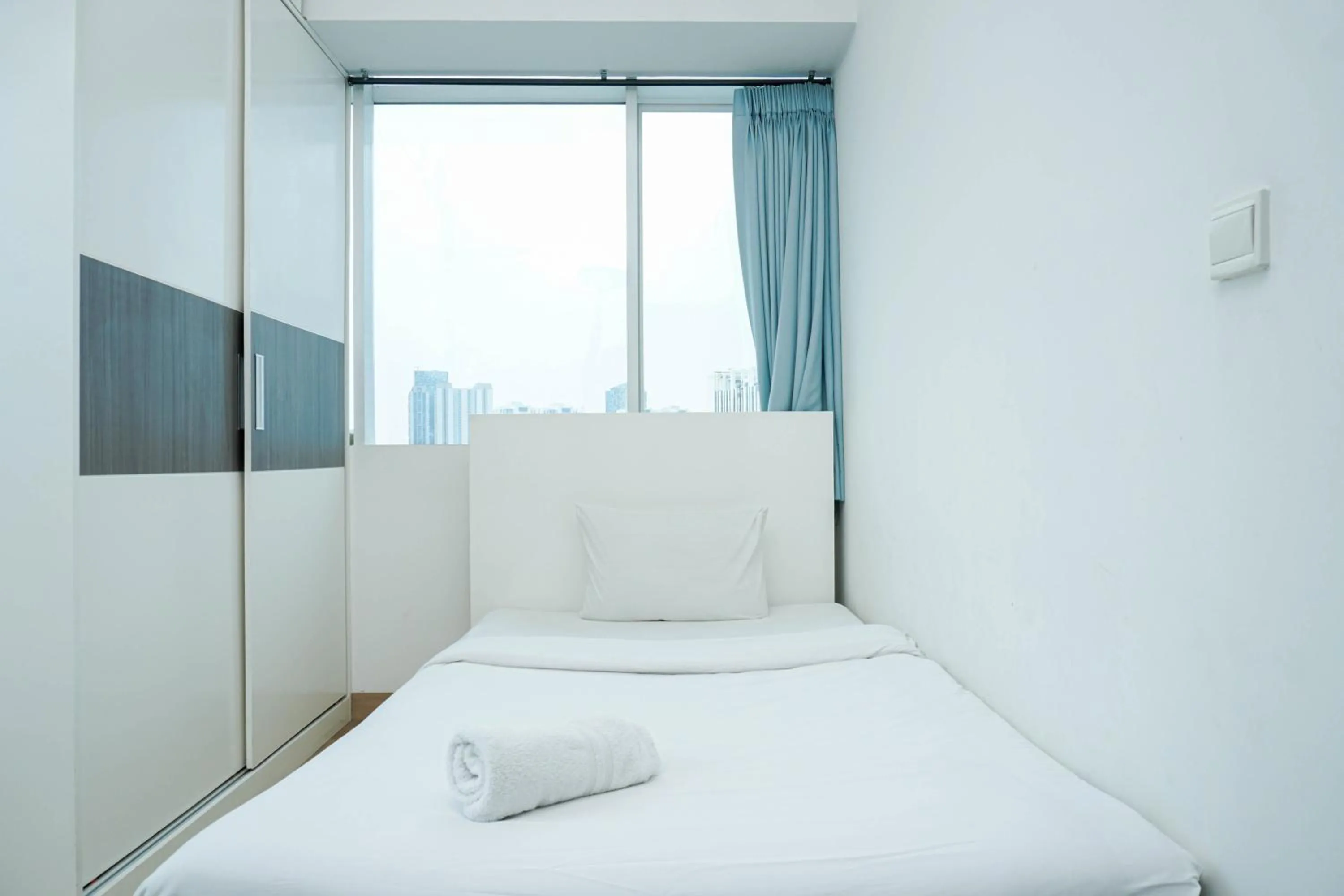 Bed in Spacious 3BR Ambassade Kuningan Apartment By Travelio