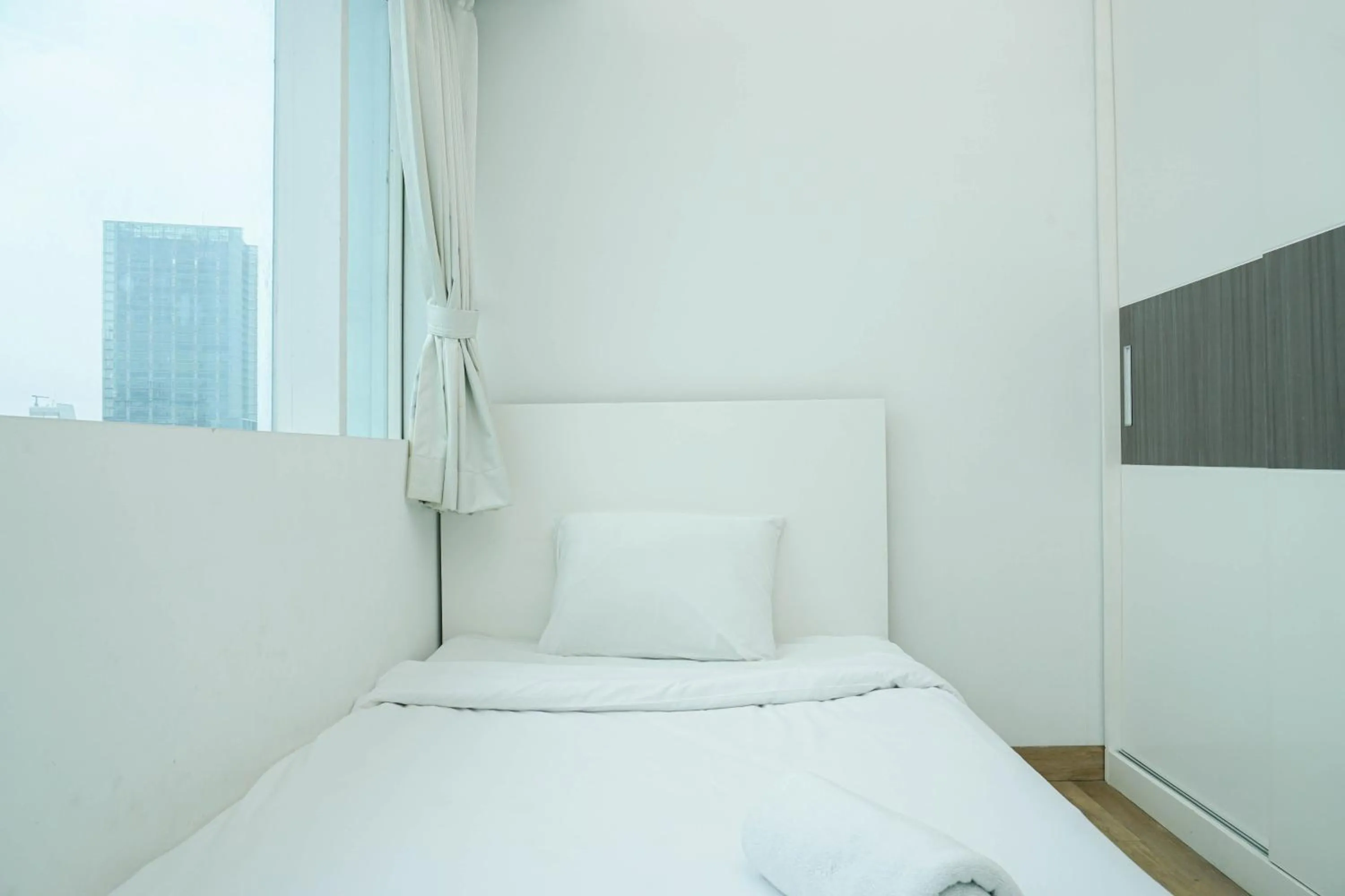 Bed in Spacious 3BR Ambassade Kuningan Apartment By Travelio