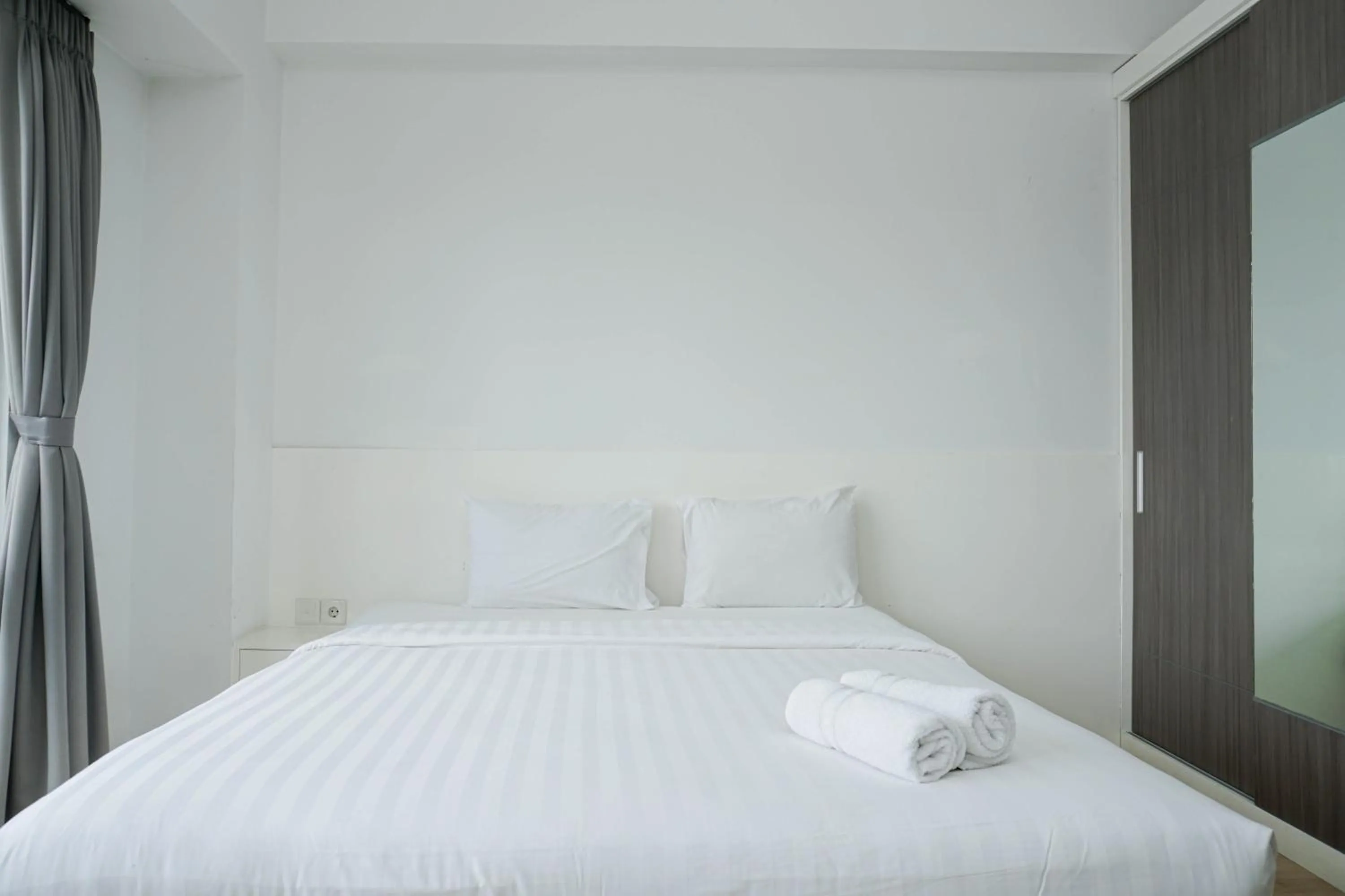 Bed in Spacious 3BR Ambassade Kuningan Apartment By Travelio
