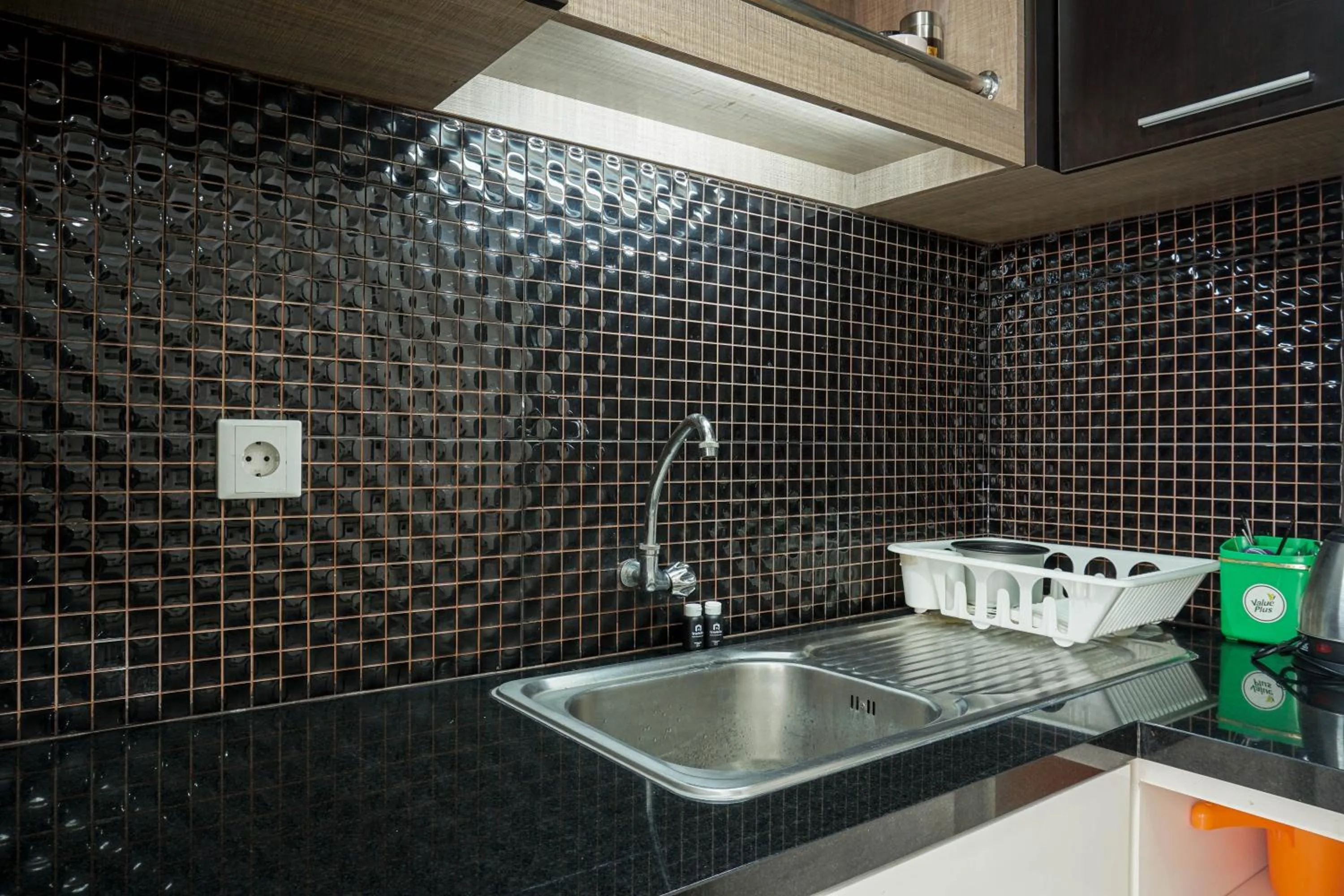 Kitchen or kitchenette in Spacious 3BR Ambassade Kuningan Apartment By Travelio