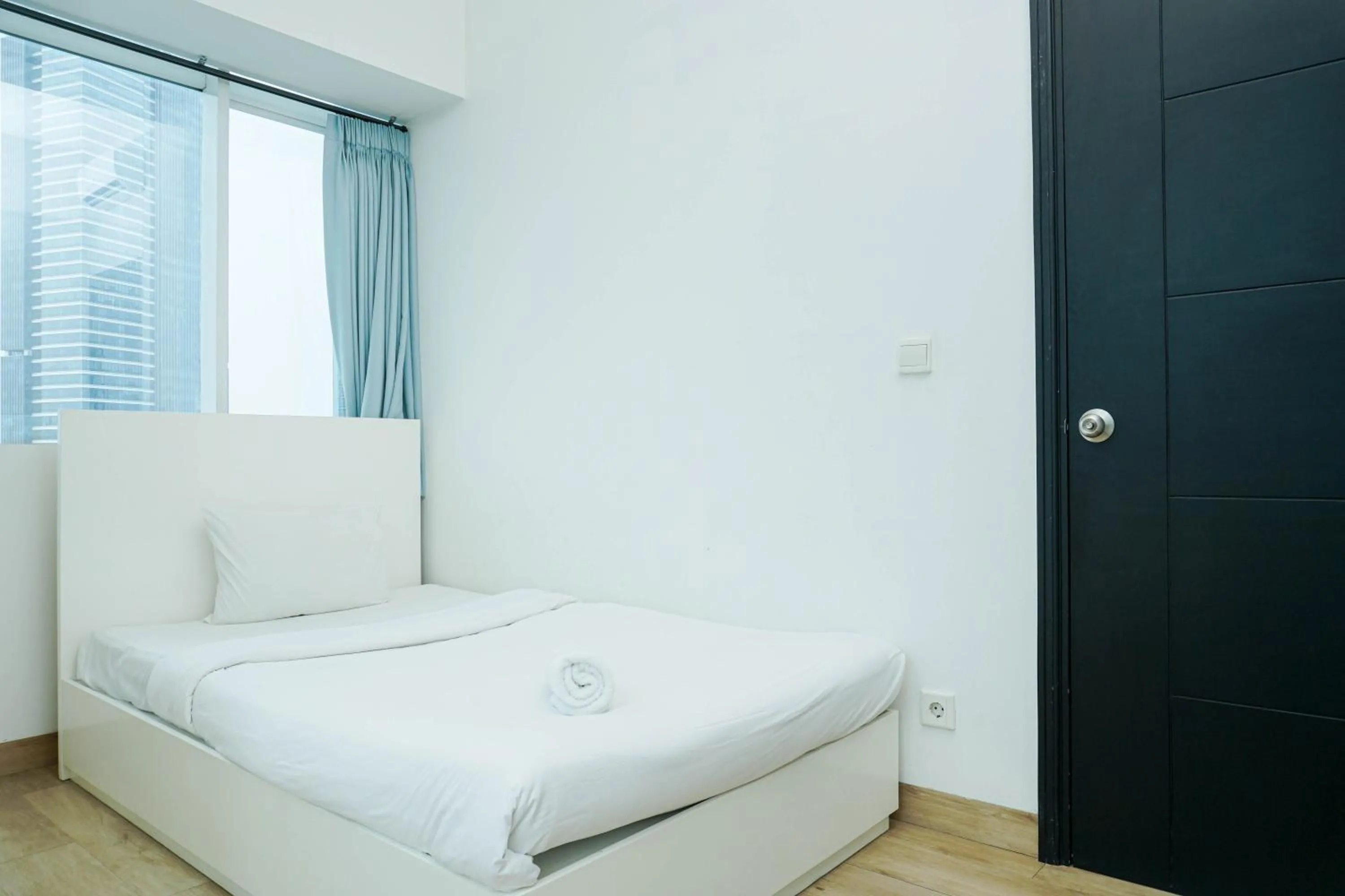Bed in Spacious 3BR Ambassade Kuningan Apartment By Travelio