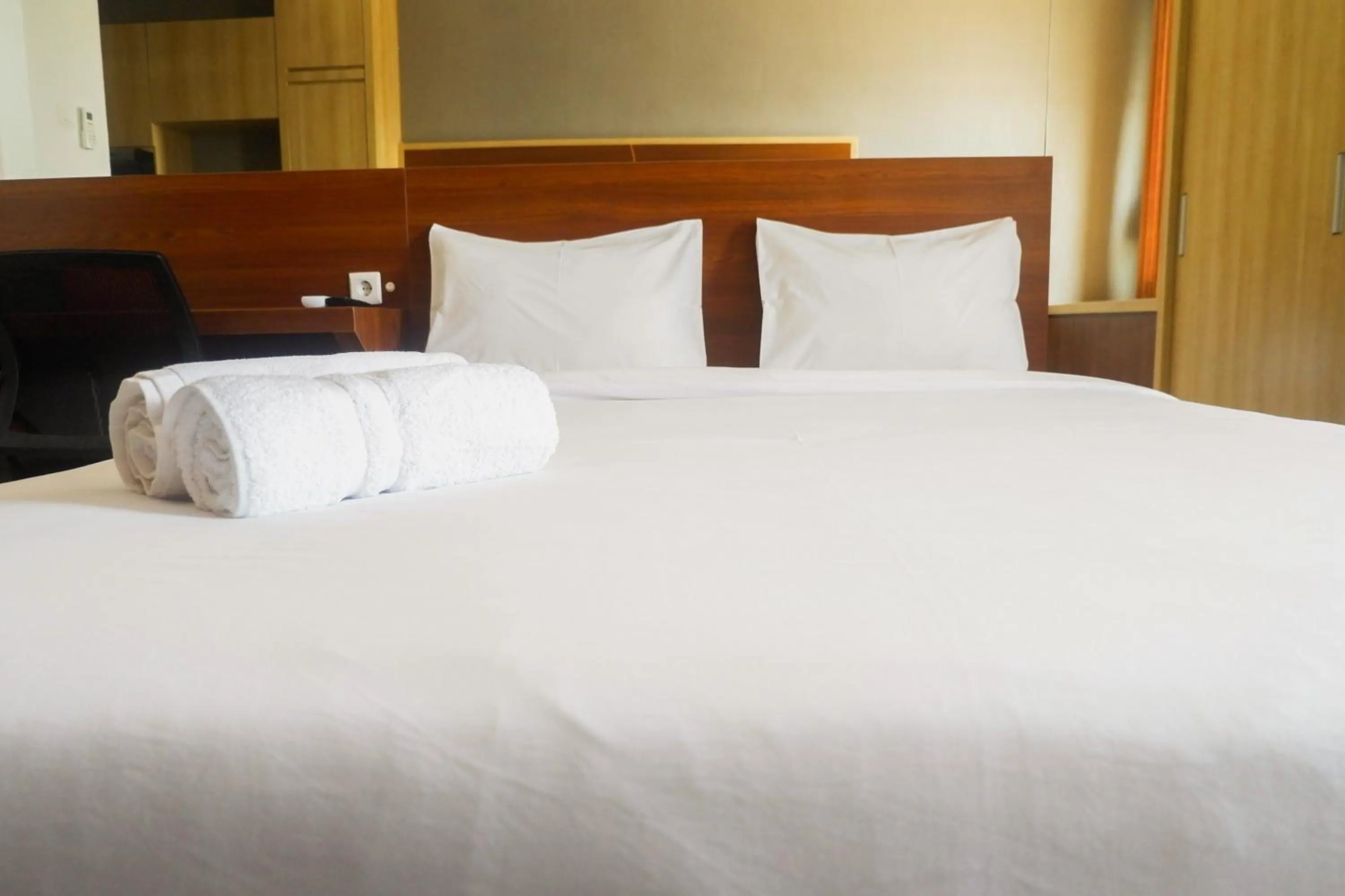 Bed in Comfy Studio Apartment at Menara Rungkut By Travelio