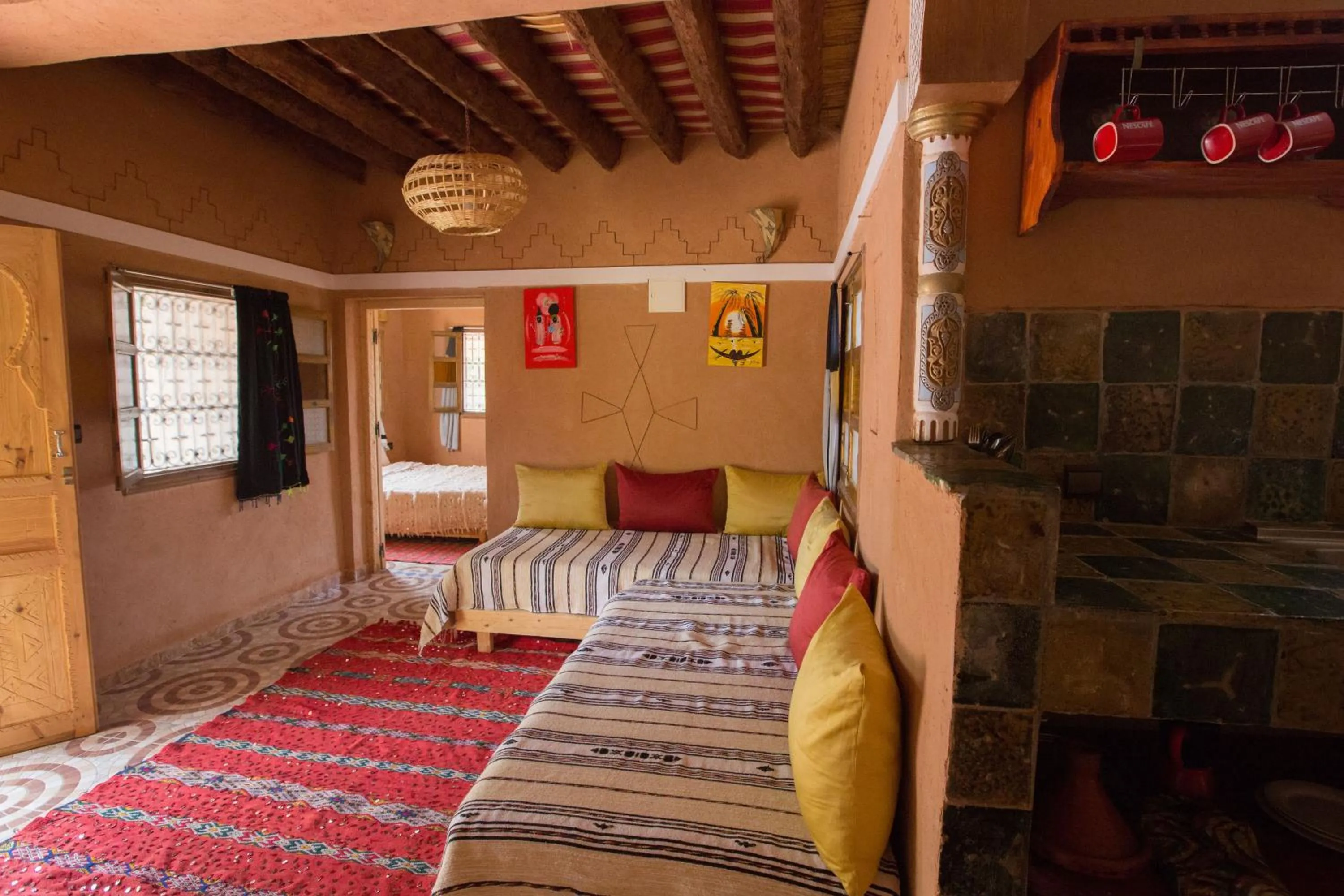 Living room, Bed in Ecolodge La Palmeraie