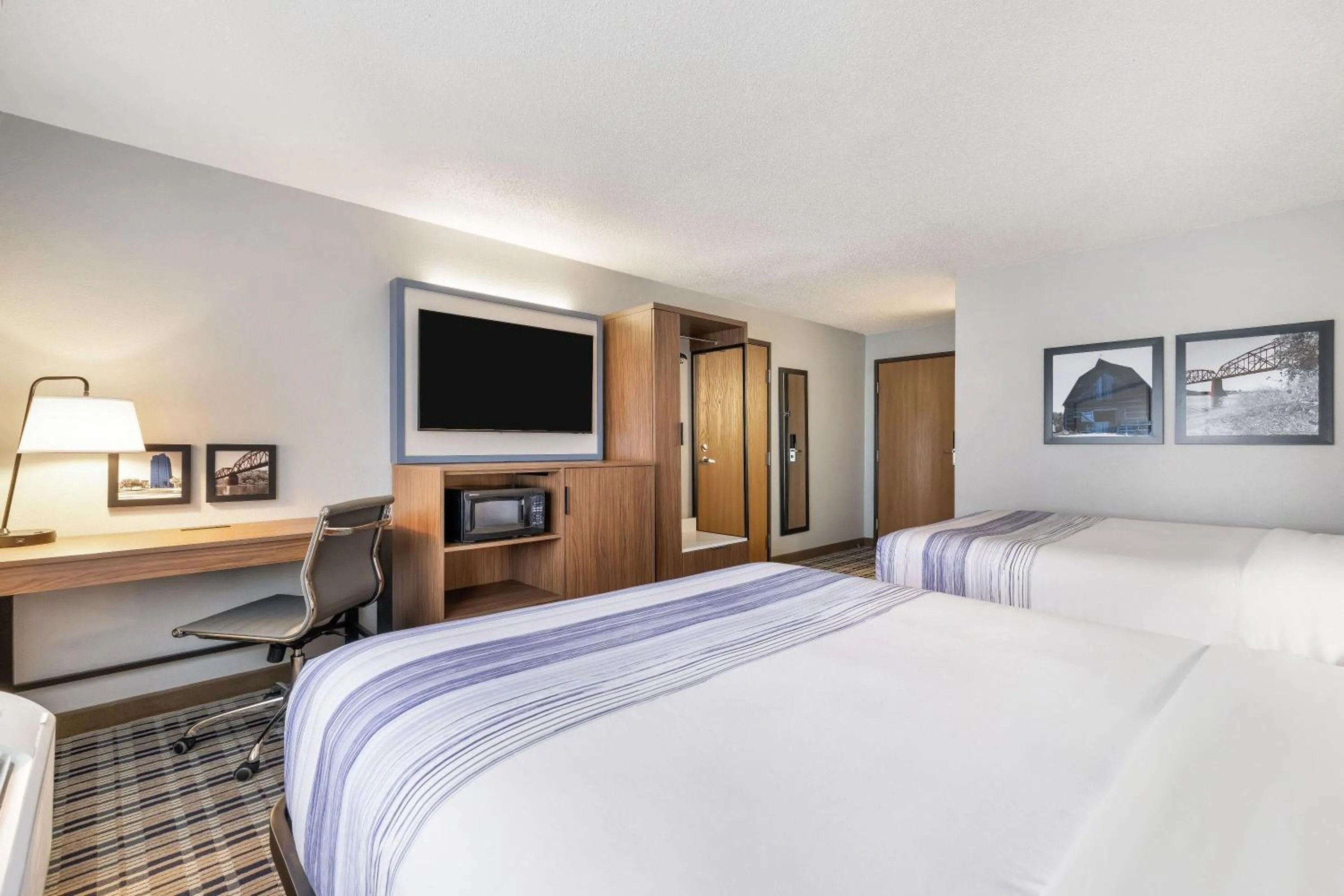 Bed in AmericInn by Wyndham Bismarck