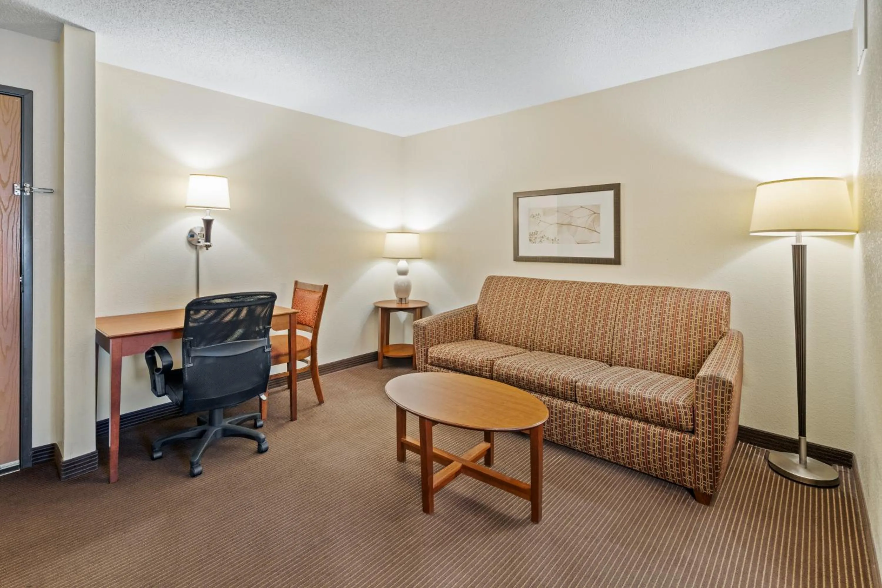 Living room in AmericInn by Wyndham Bismarck
