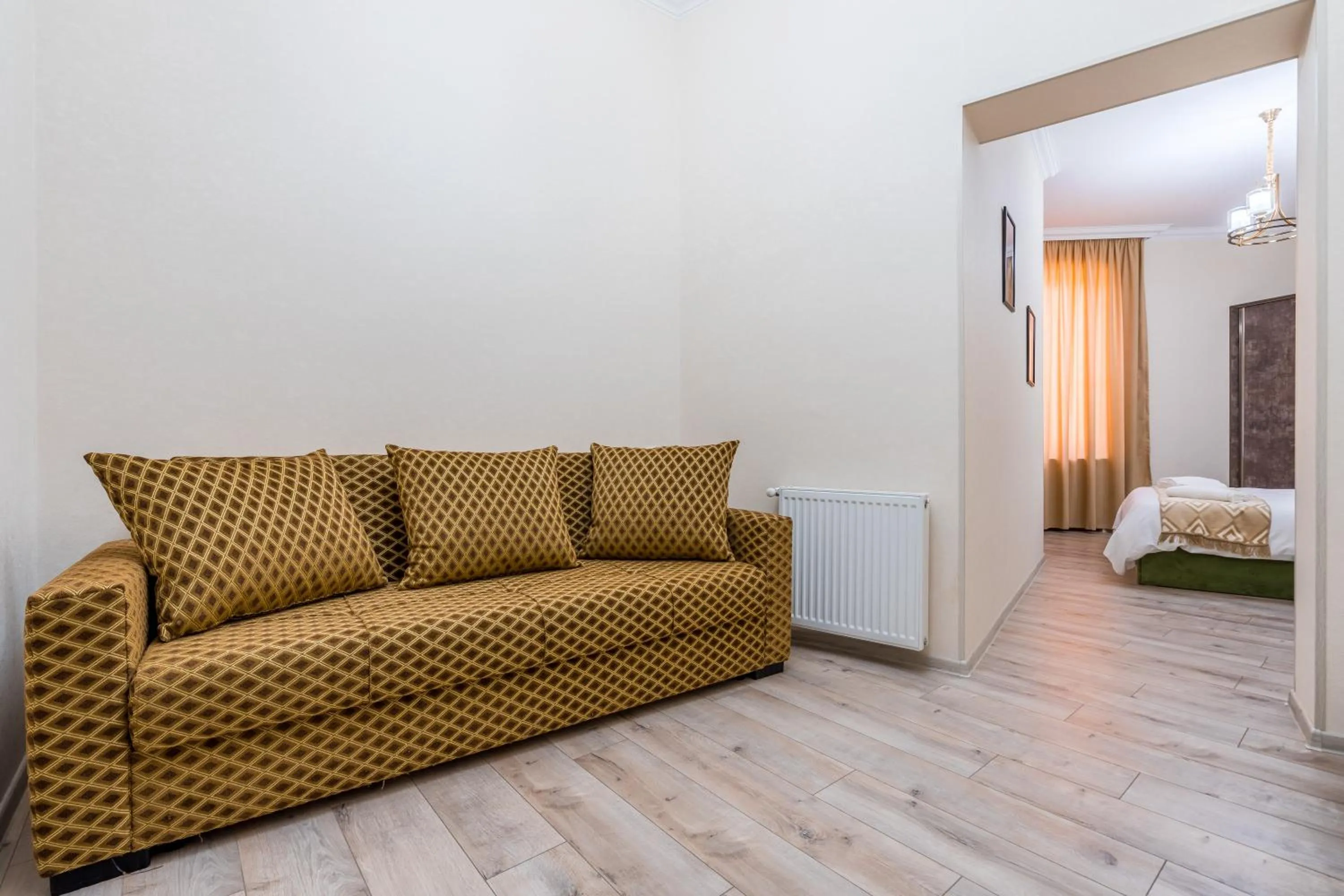 Seating area, Bed in Golden Light Hotel
