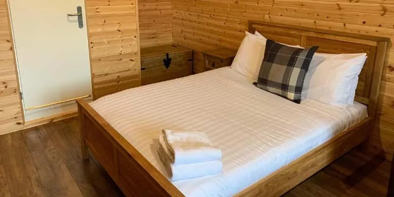 Bed in Superior Glamping Pod with Hot Tub
