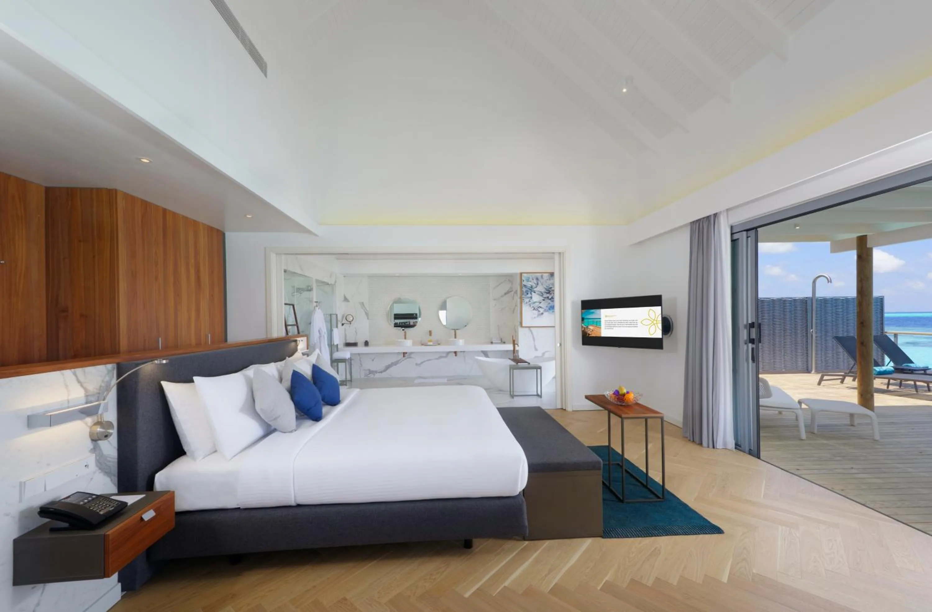 Living room, Bed in OUTRIGGER Maldives Maafushivaru Resort - 25 percent discount on transfers for min 4 nights stay and more, valid for reservations between 01 July till 22 Dec 2025