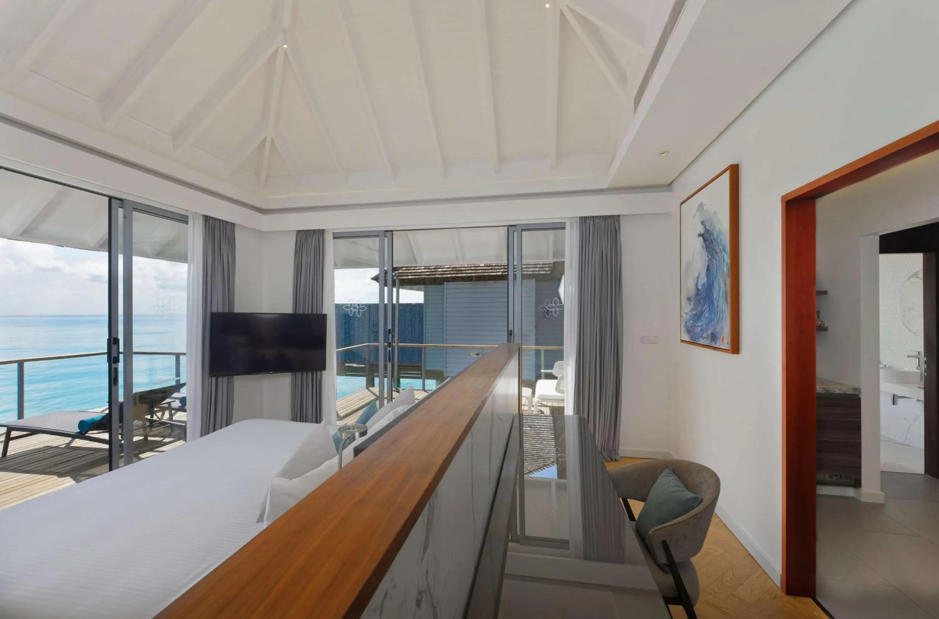 Photo of the whole room, Bed in OUTRIGGER Maldives Maafushivaru Resort - 25 percent discount on transfers for min 4 nights stay and more, valid for reservations between 01 July till 22 Dec 2025