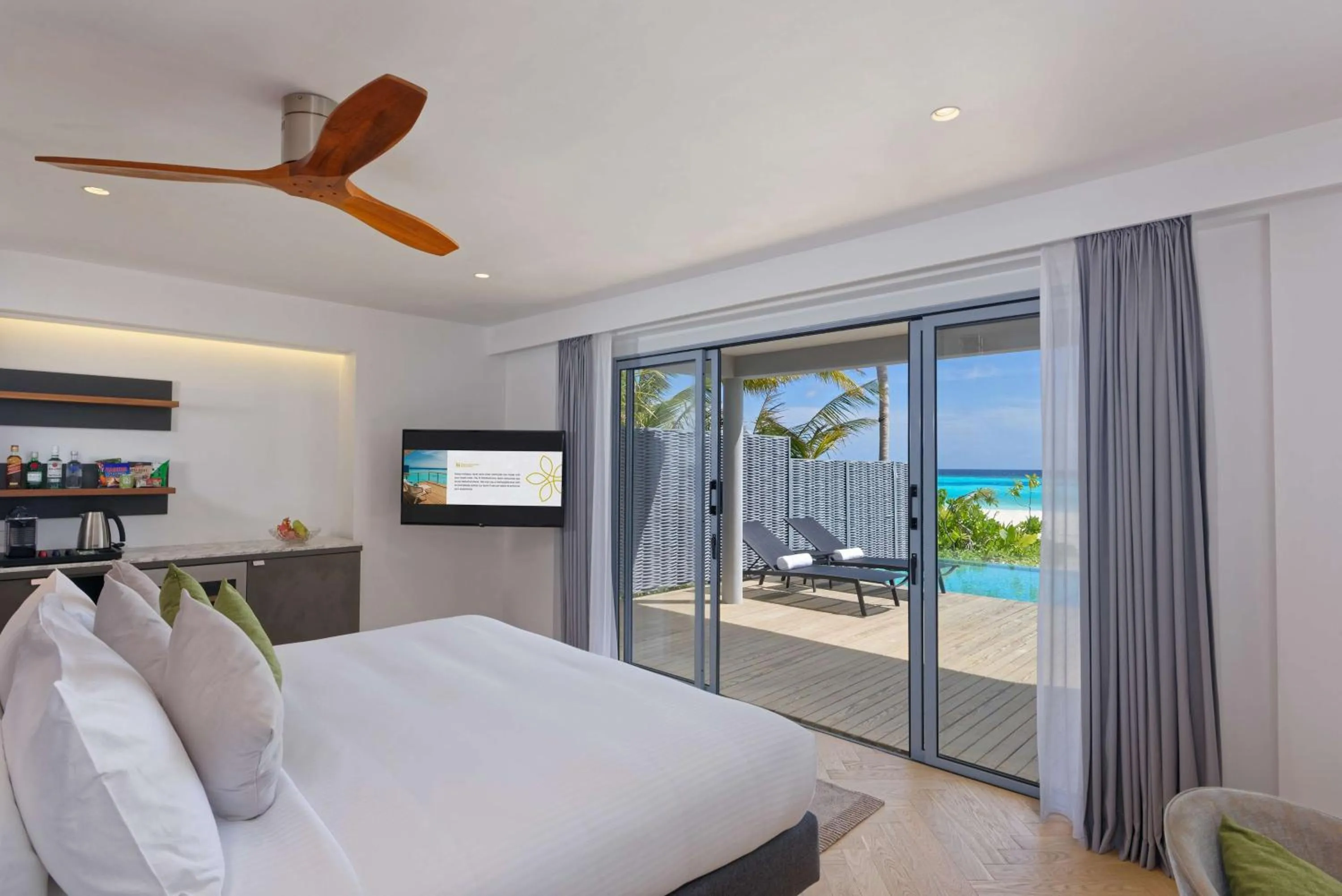 Photo of the whole room, Bed in OUTRIGGER Maldives Maafushivaru Resort - 25 percent discount on transfers for min 4 nights stay and more, valid for reservations between 01 July till 22 Dec 2025