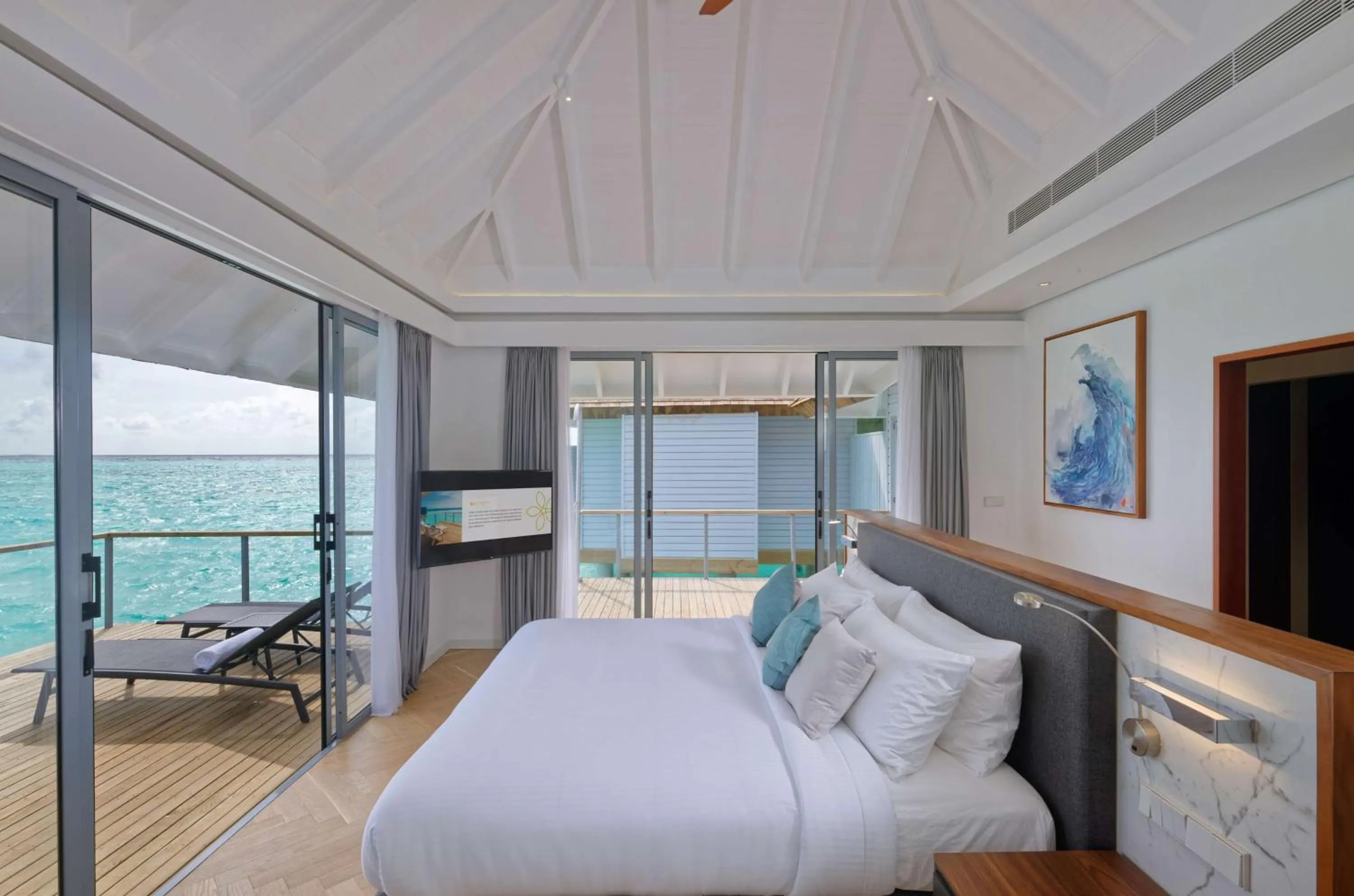 Photo of the whole room, Bed in OUTRIGGER Maldives Maafushivaru Resort - 25 percent discount on transfers for min 4 nights stay and more, valid for reservations between 01 July till 22 Dec 2025