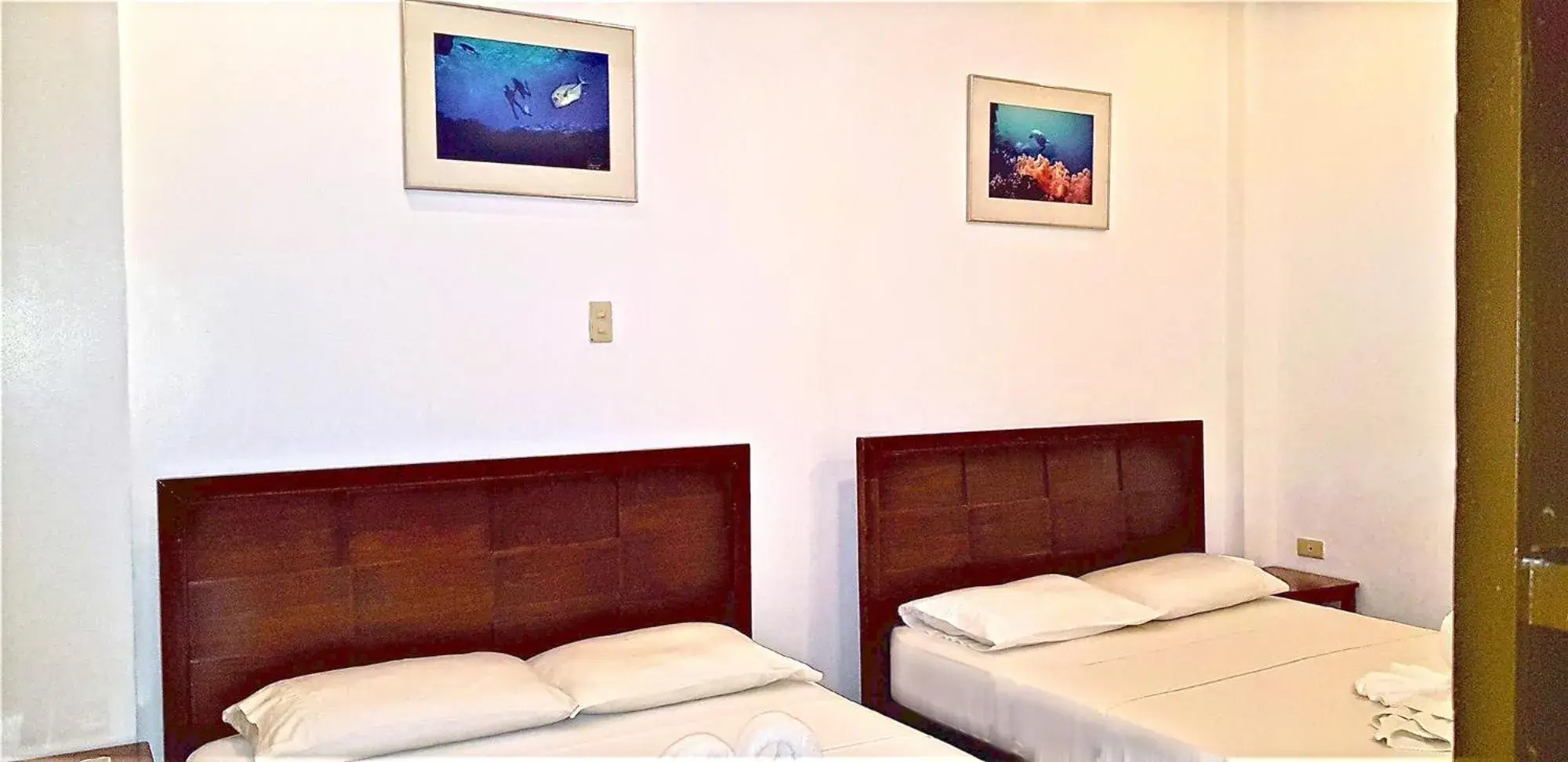 Bed in DiveGurus Boracay Beach Resort Bed in DiveGurus Boracay Beach Resort