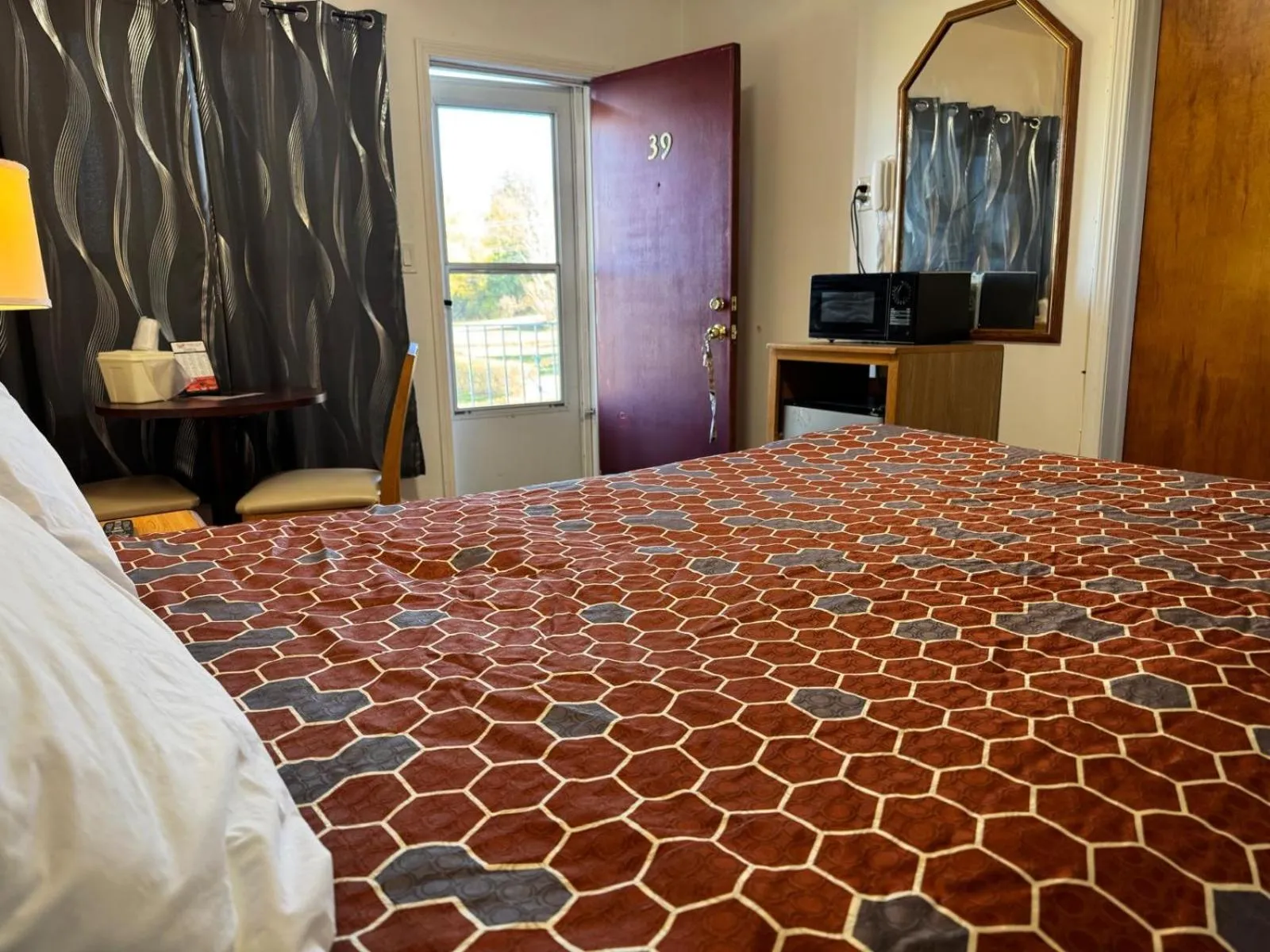 Bedroom, Bed in Economy Inn Cadillac MI by Hotel O