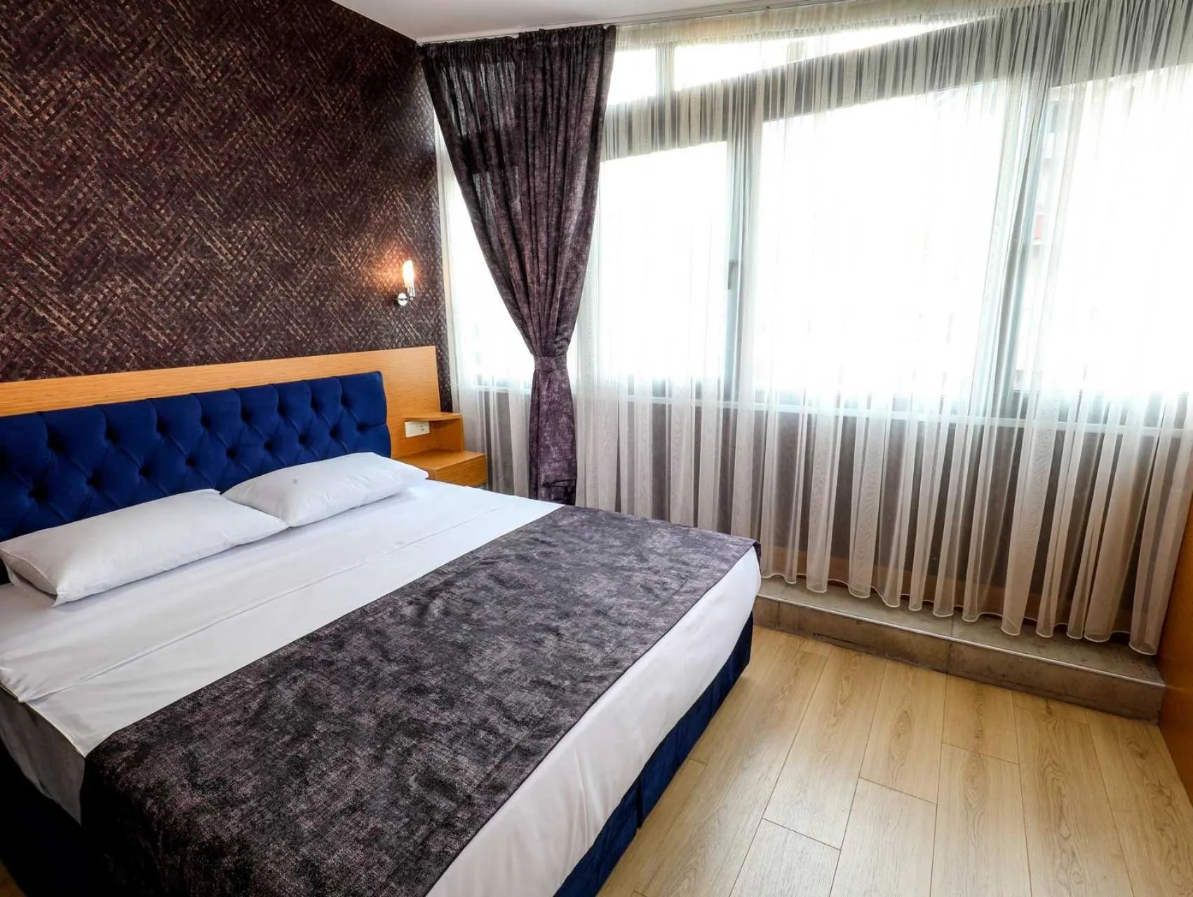 Bed in Grand Elmira Suites