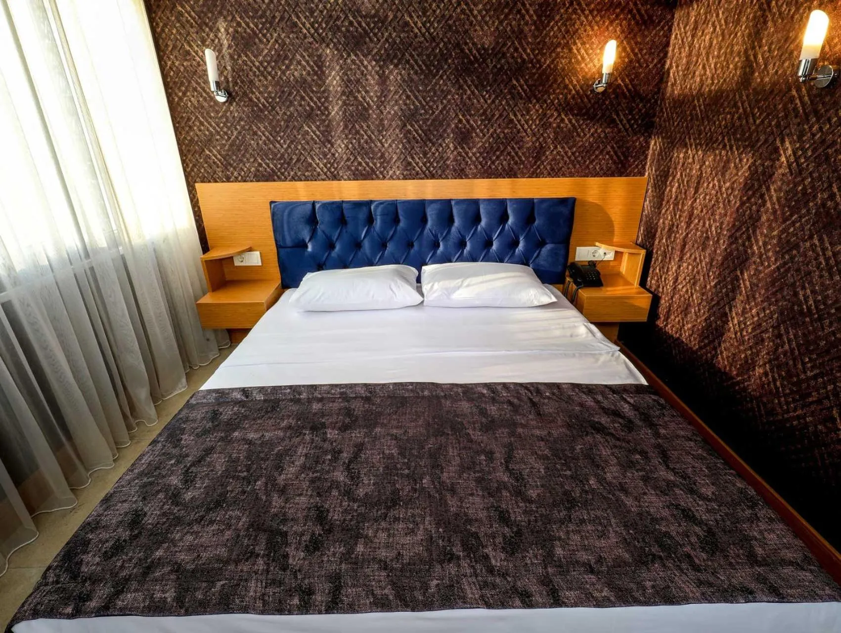 Bed in Grand Elmira Suites