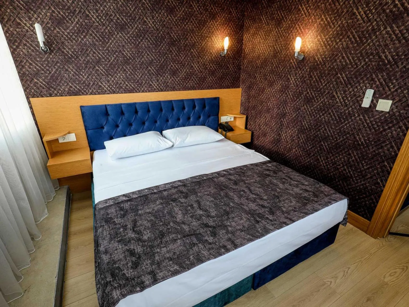 Bed in Grand Elmira Suites