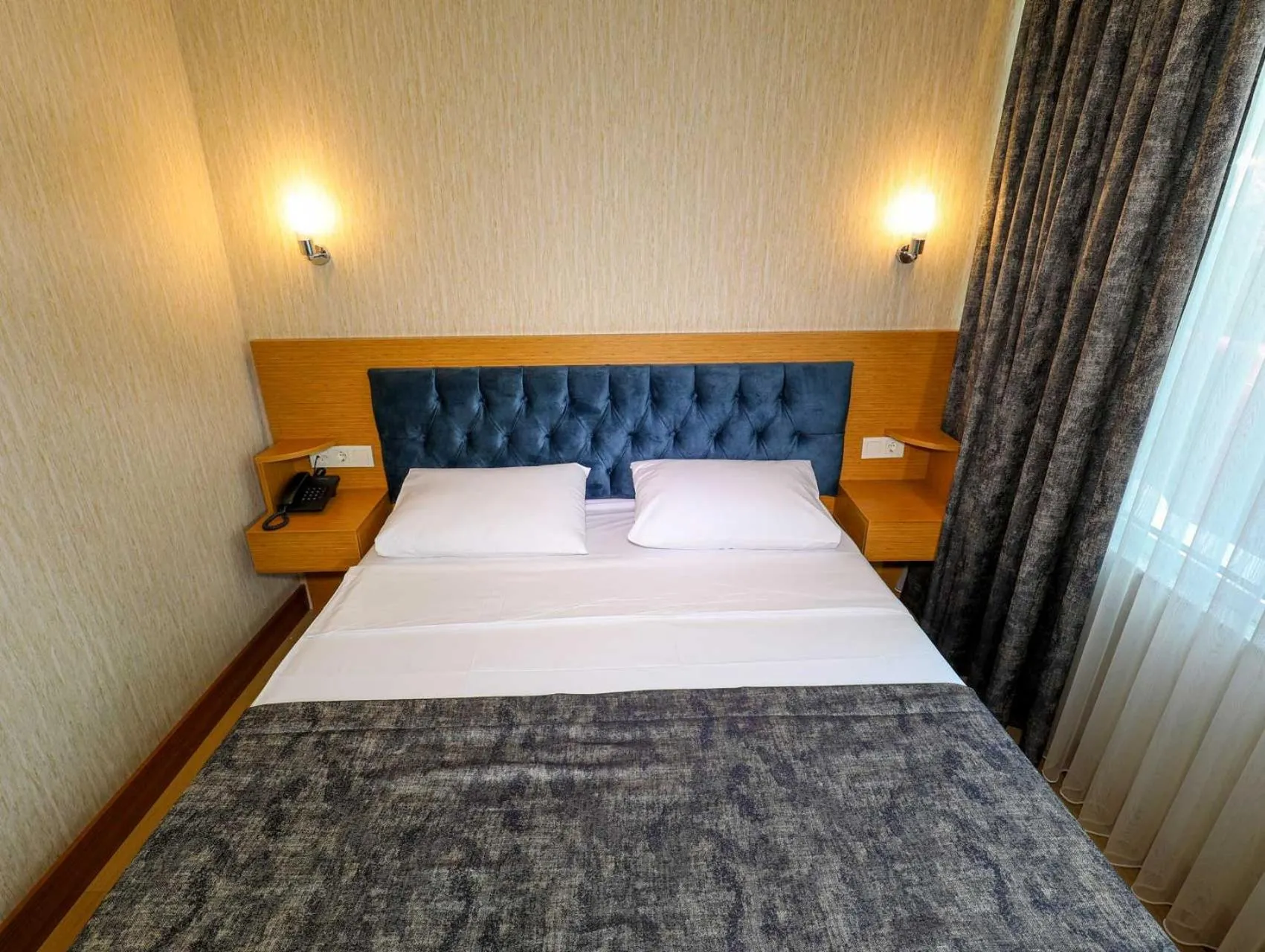 Bed in Grand Elmira Suites