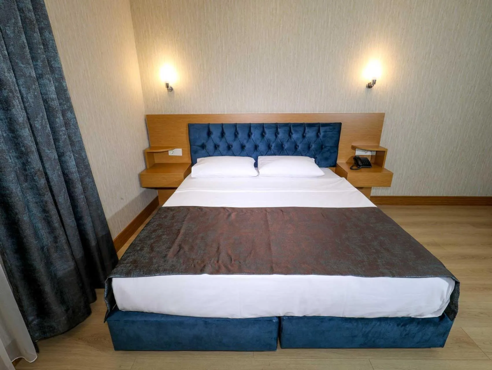 Bed in Grand Elmira Suites