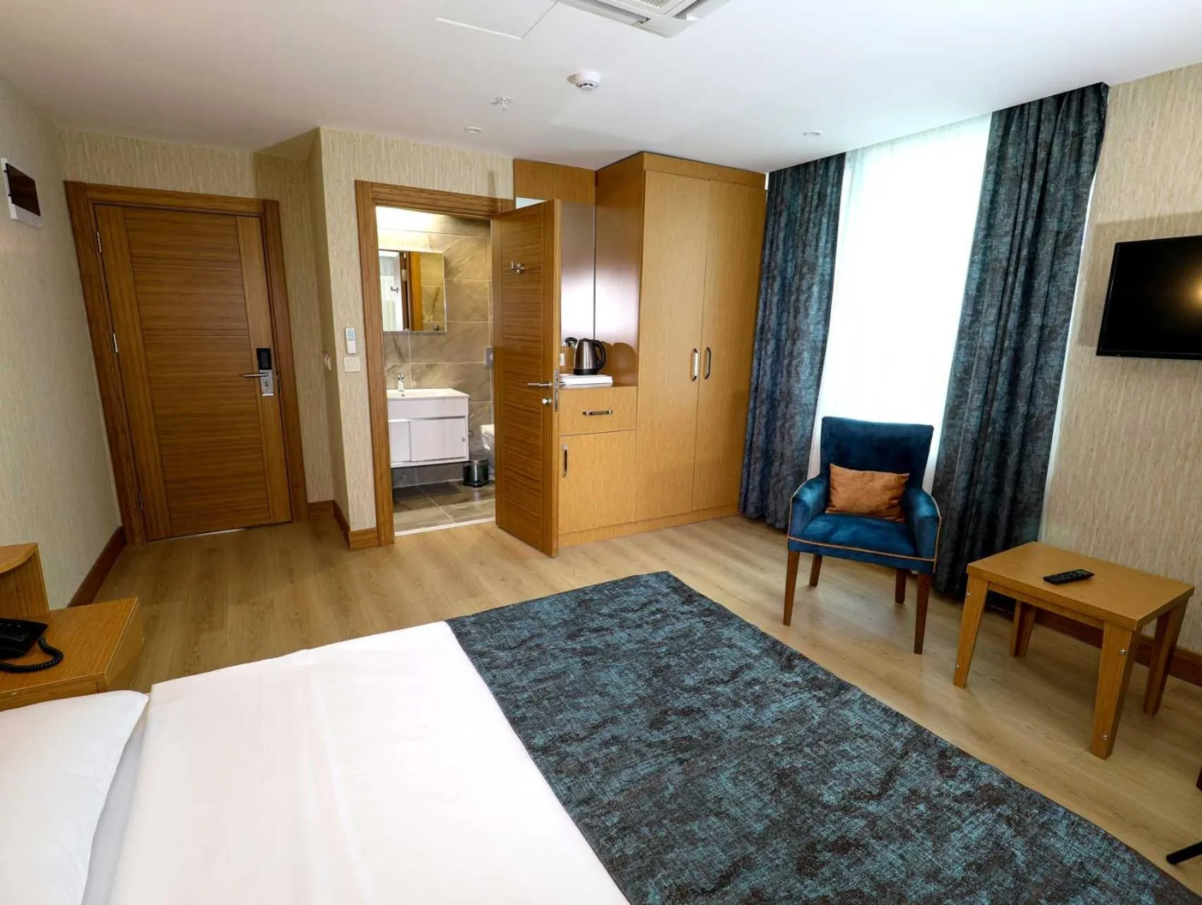 Bed in Grand Elmira Suites