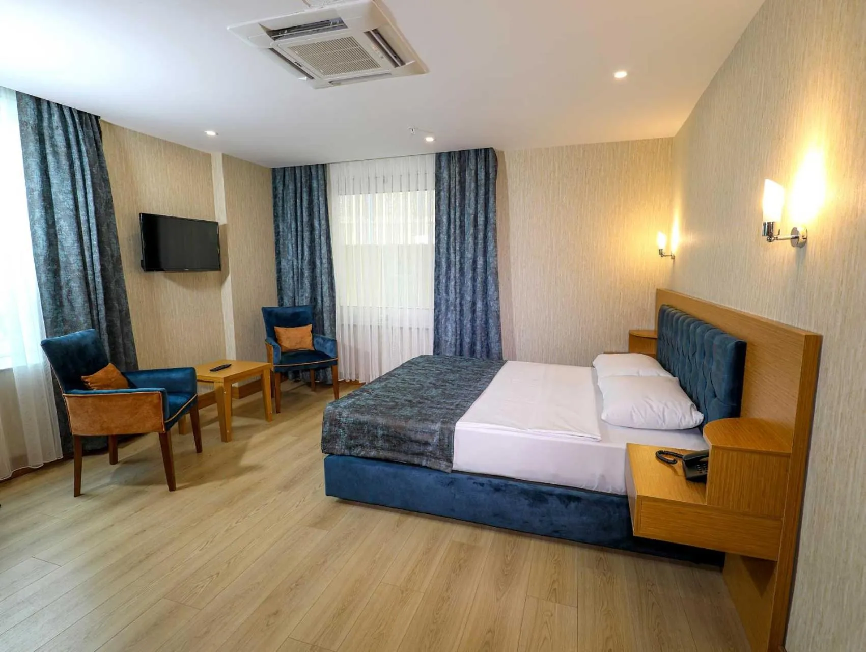 Bed in Grand Elmira Suites