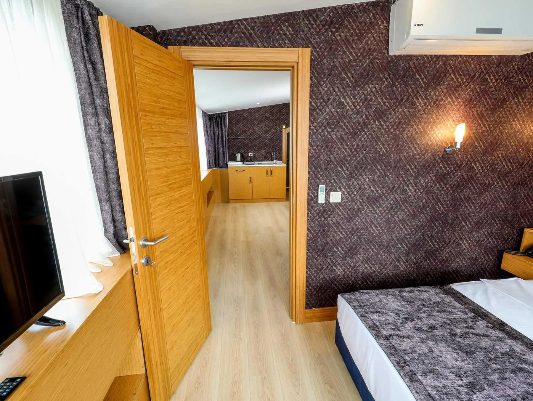 Bed in Grand Elmira Suites