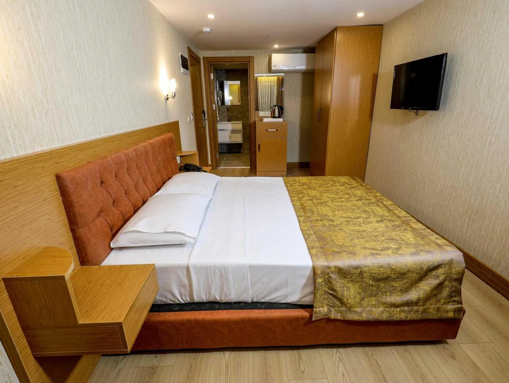 Bed in Grand Elmira Suites