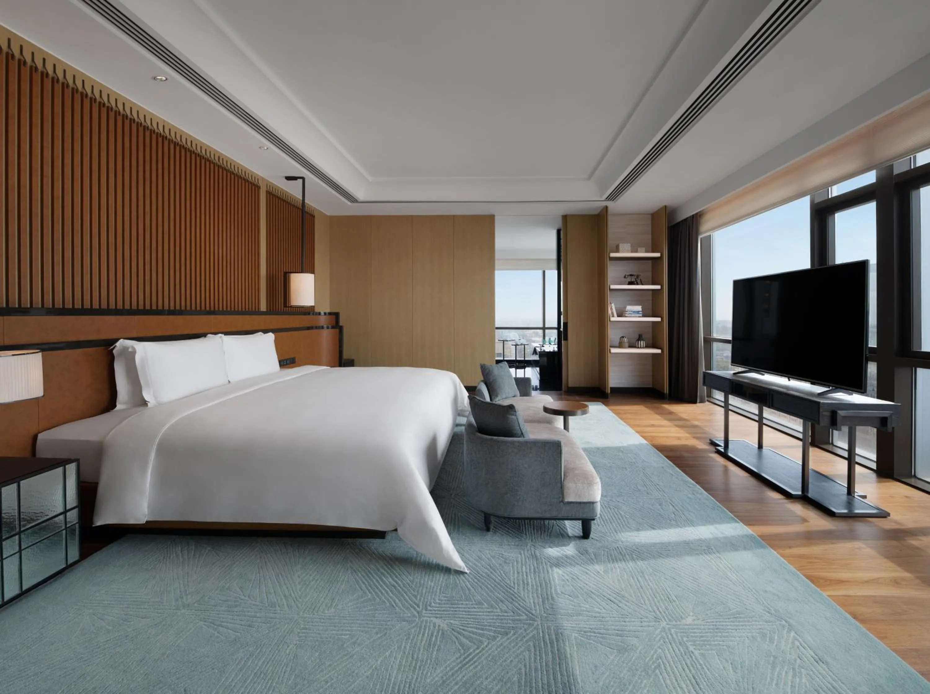 Bed in New World Langfang Hotel