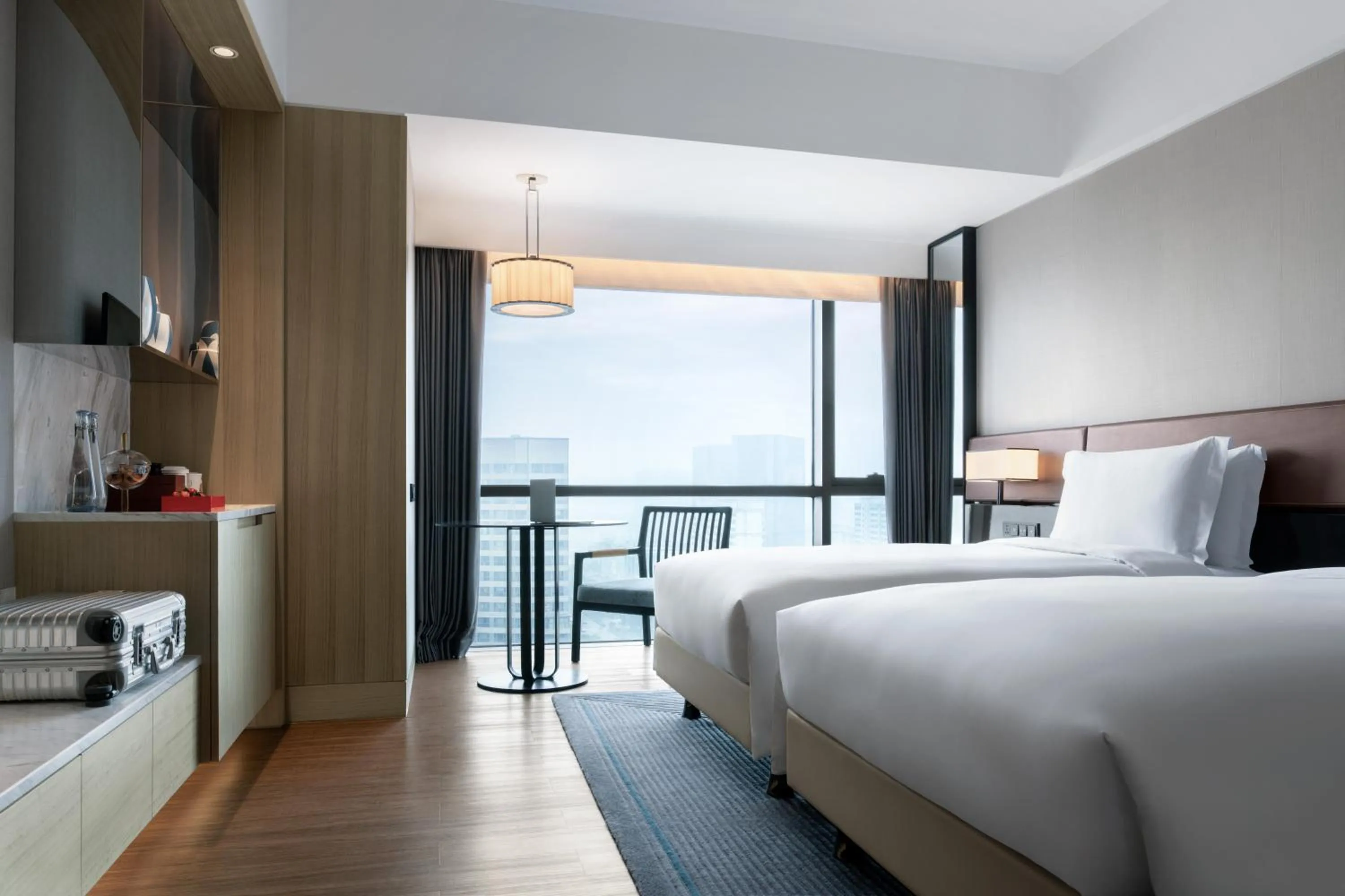 Bed in New World Langfang Hotel