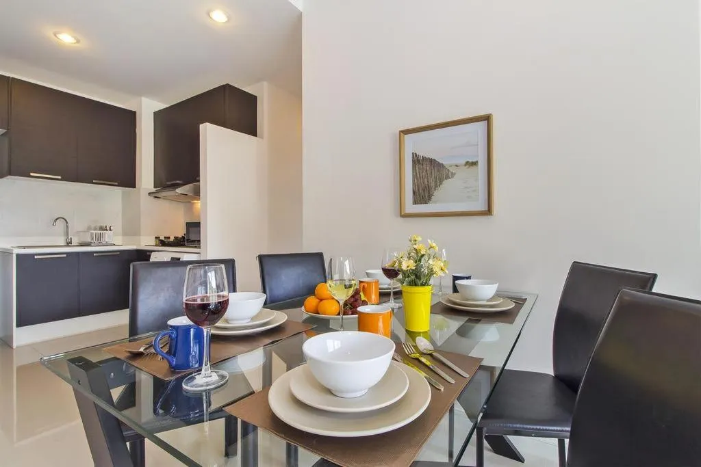 Dining area in Chic Condo by RESAVA