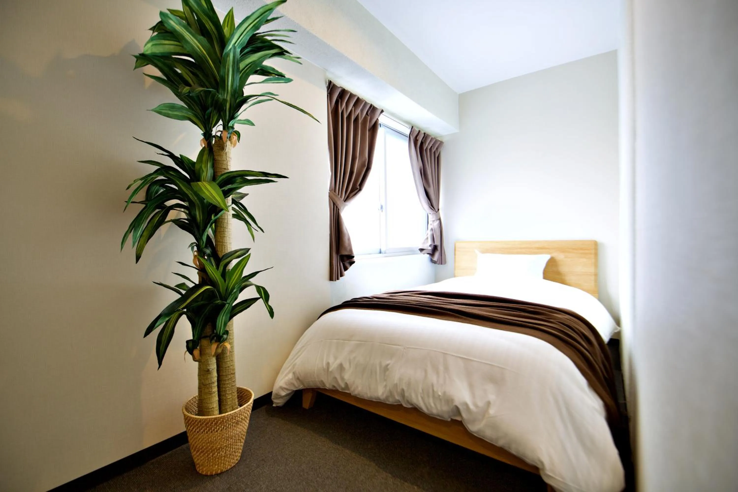 Bed in KURA HOTEL IZUMISANO