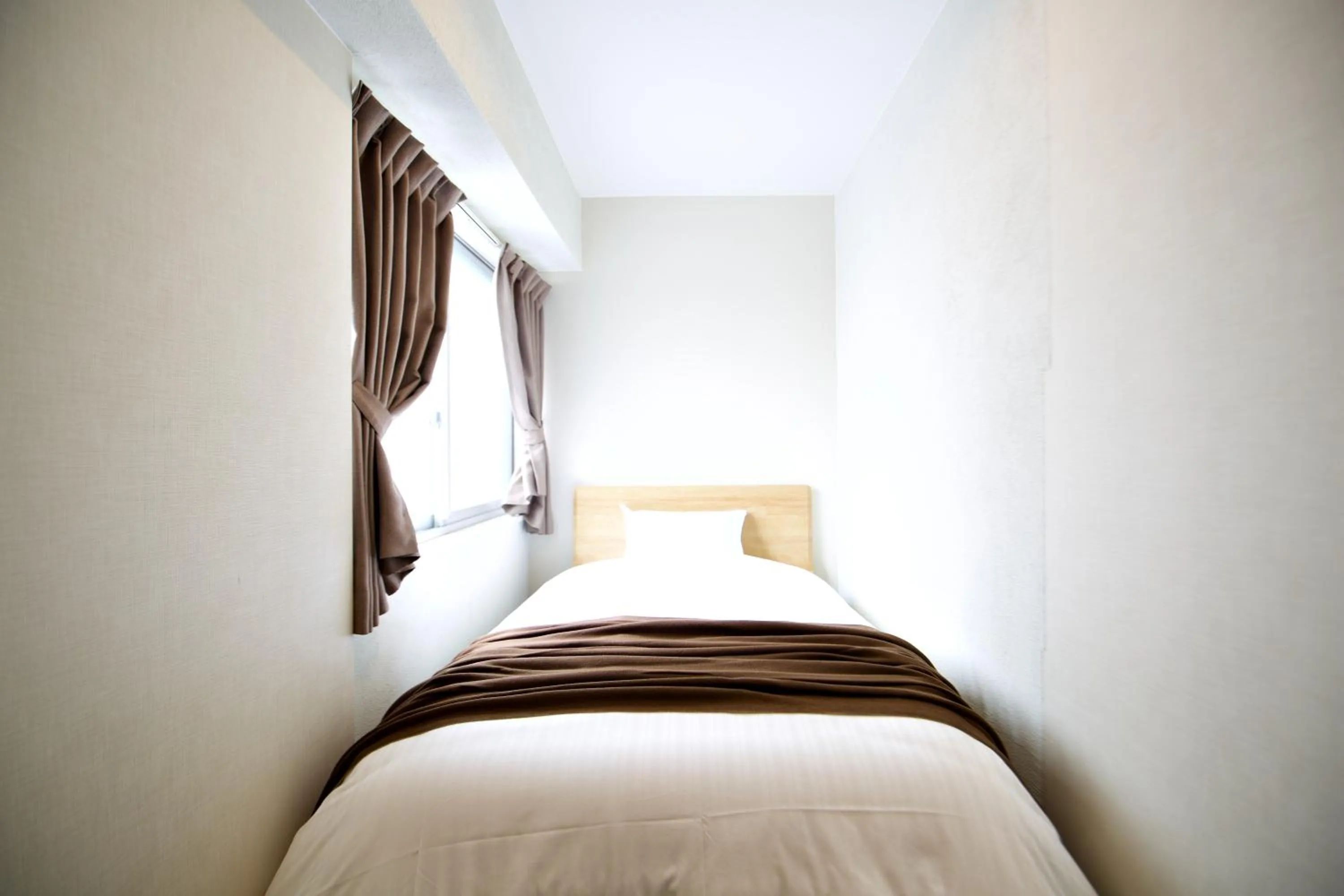 Bed in KURA HOTEL IZUMISANO