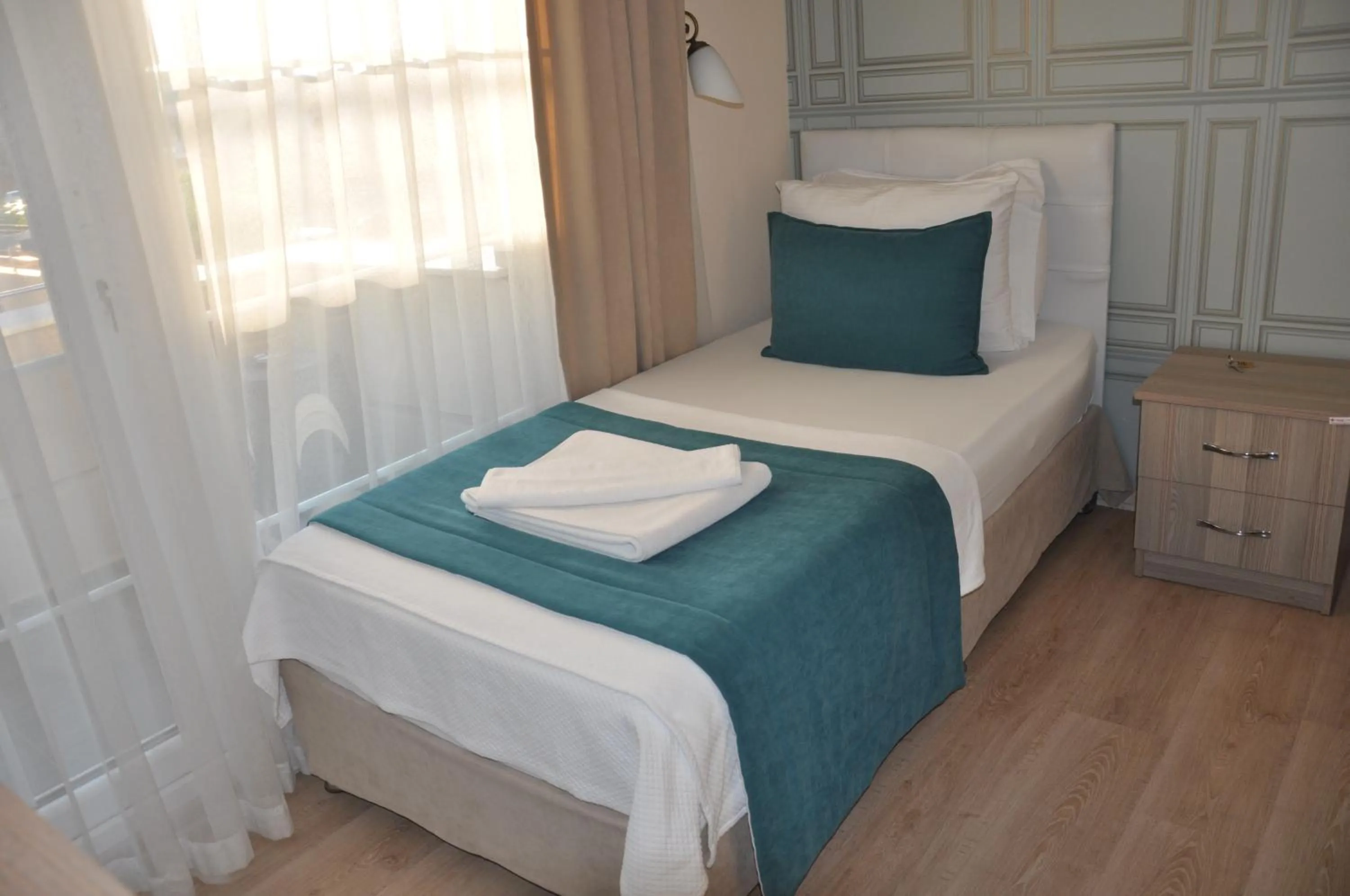 Bed in Neoss Boutique Hotel