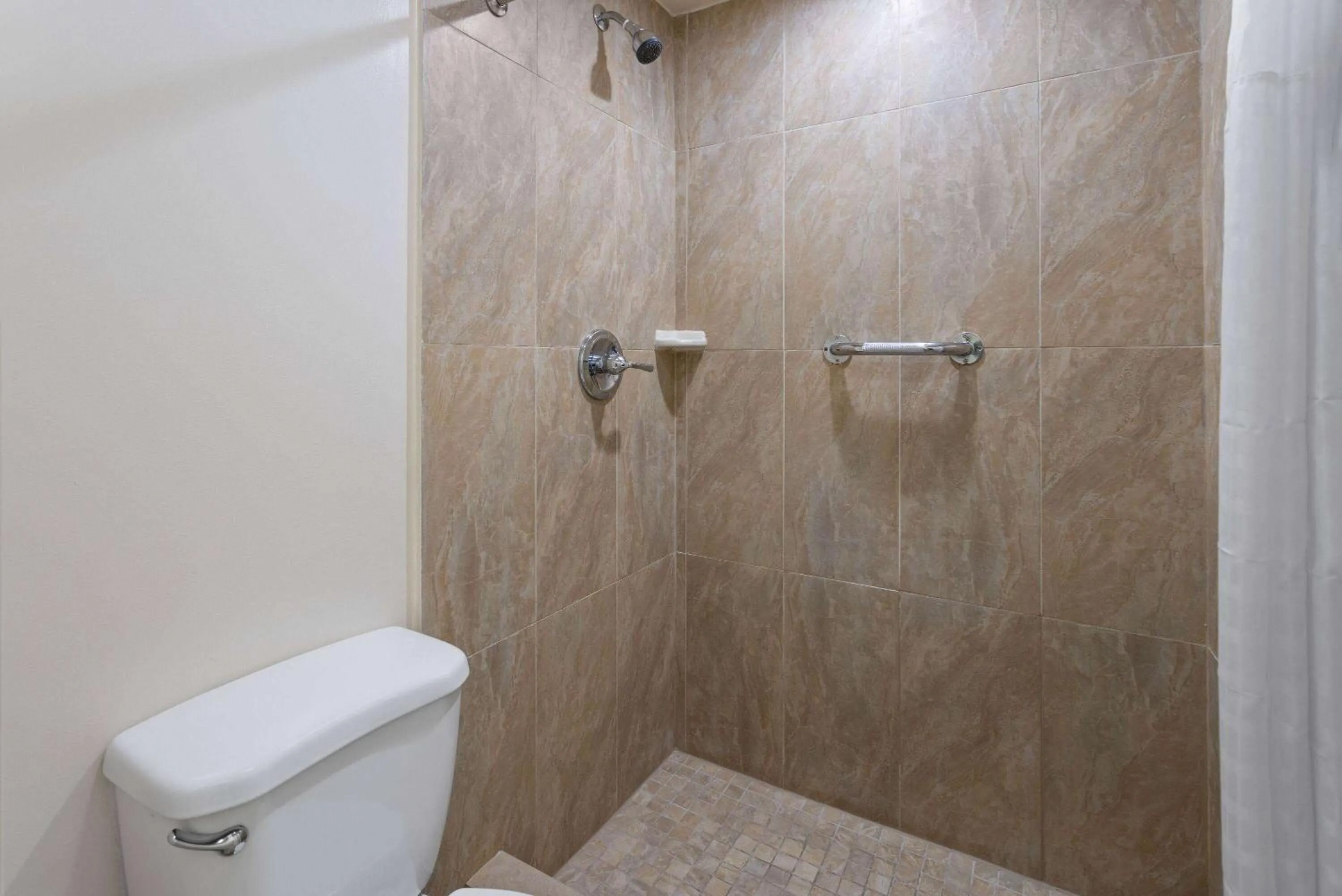 Bathroom in Travelodge by Wyndham Manhasset